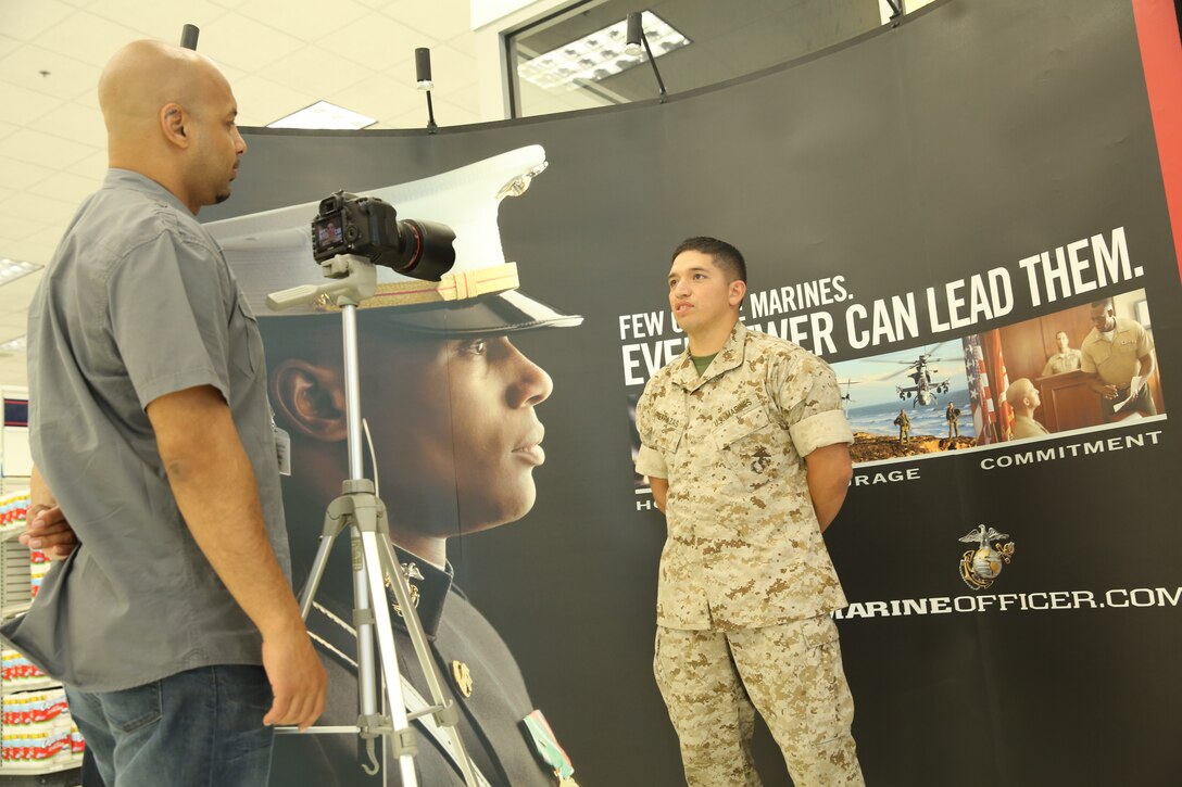2nd Lt. Gustavo Terrazas, student, Basic Communications Officers' Course, Marine Corps Communication-Electronics School, explains his reason to seek participation in Marine Corps casting to Yirayah Garcia, associate social director, J. Walter Thompson casting agency, during the Marine Corps Recruiting Command consolidated casting call held at the base exchange, April 28, 2014. The casting tour traveled to several Marine Corps installations across the continental United States to seek Marines. (Official Marine Corps photo by Lance Cpl. Paul S. Martinez/Released)