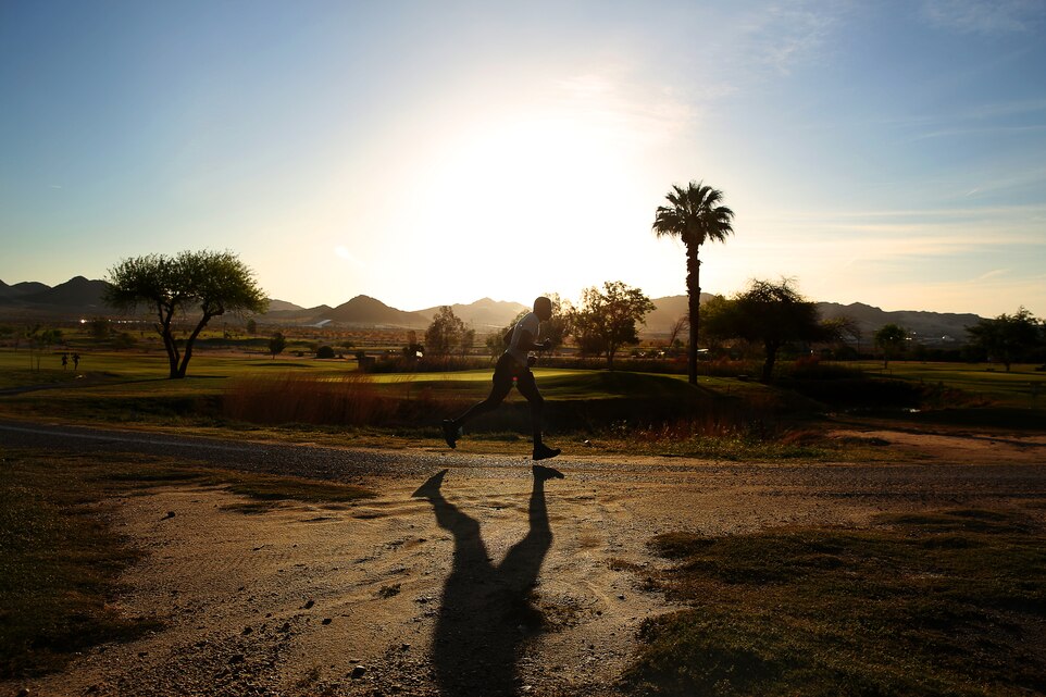 A runner pushes through the last 100 meters of the 5K Earth Day Fun Run at Desert Wind’s Golf Course April 25, 2014. The run was held in celebration of Earth Day, combining fun and awareness. (Official USMC photo by Cpl. Ali Azimi/Released)