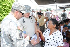 U. S. Army Lt. Col. Robert Walkup with the assistance of his translator U. S. Army Spc. William Baez, answers a Honduran woman's question about preventive health care.  Joint Task Force-Bravo's Medical Element (MEDEL), with support from all Joint Task Force-Bravo commands, hosted the Soto Cano Air Base Senior Health Engagement providing valuable health and wellness information, a base tour, and some entertainment to 133 Honduran senior citizens from Cane, La Paz, April 30.  The group received health screenings and patient education related to blood pressure, blood sugar, exercise, muscle strength, balance and good oral hygiene as they age.  After the screenings and classes were finished, the group of senior citizens was able to turn back the hands of time and act young again as they were treated to dance lessons and the opportunity to dance with members from Joint Task Force-Bravo.  (Photo by U. S. Air National Guard Capt. Steven Stubbs)