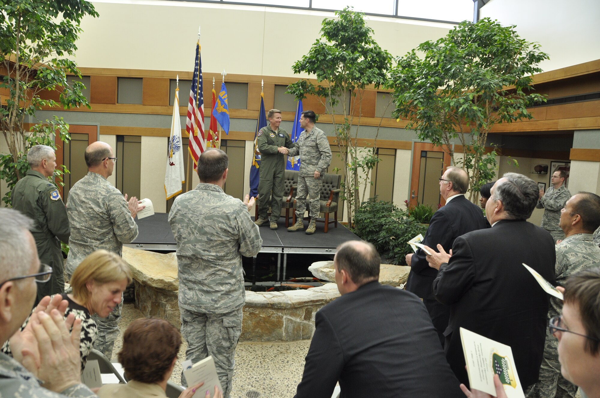Brig. Gen. Patrick Doherty, Air Force Services director, congratulates Col. John M. Devillier, Air Force Mortuary Affairs Operations commander, May 1, 2014, at the conclusion of a ceremony commemorating the transition of AFMAO from a named activity to a Field Operating Agency, aligning the organization directly under Headquarters Air Force. (U.S. Air Force photo/Tech. Sgt. Myco Apat)