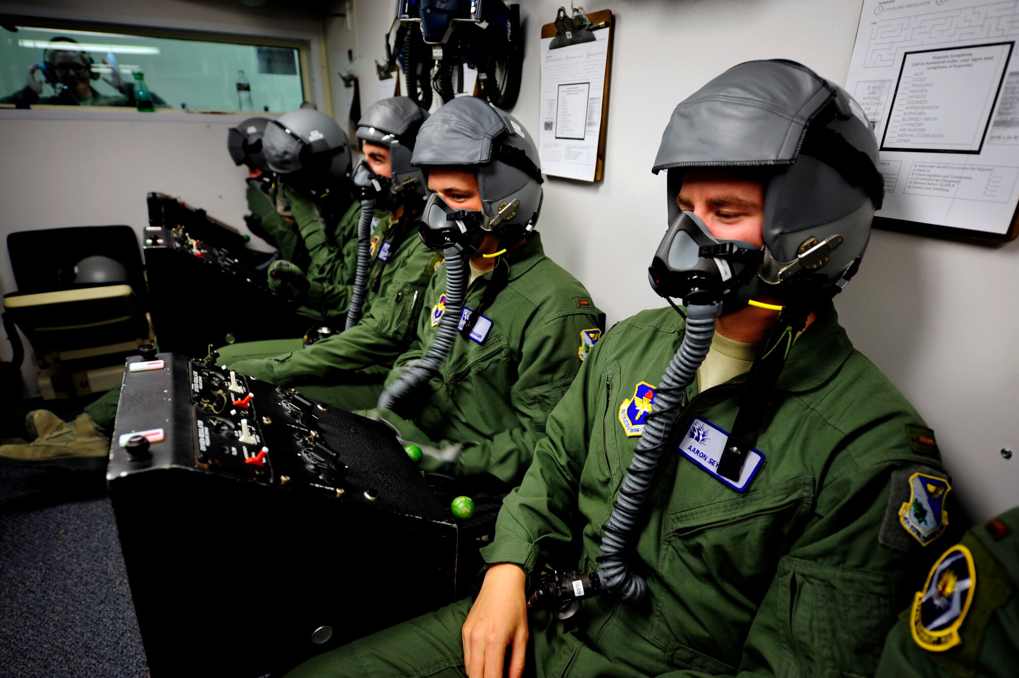 Second Lt. Aaron Seyfried, 47th Student Squadron student pilot, awaits a seal check in the hypobaric chamber at the Aerospace Physiology Unit on Laughlin Air Force Base, Texas, April 30, 2014. Undergraduate Pilot Training students are exposed to low-pressure altitude flights to experience the onset of hypoxia, or a lack of oxygen to the blood and brain, as part of the physiology training required of all military aviators. (U.S. Air Force photo/Staff Sgt. Steven R. Doty/Released)