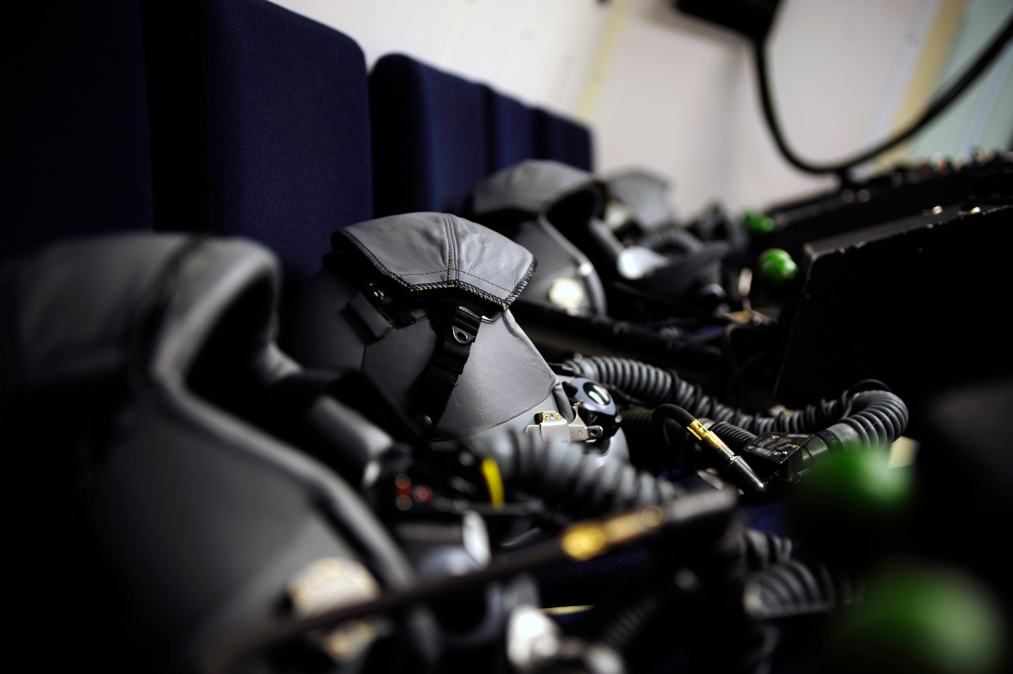Flight helmets sit ready in the hypobaric chamber at the Aerospace Physiology Unit on Laughlin Air Force Base, Texas, April 30, 2014. Flight helmets began as a leather head piece that covered the pilots head with removable googles to protect pilot’s eyes from the elements. Since World War II, additional elements and modifications, like an oxygen mask, visor, communication equipment and the hardening of the helmet, were completed to increase the helmets versatility and to meet the evolving demands of military pilots. (U.S. Air Force photo/Staff Sgt. Steven R. Doty/Released)