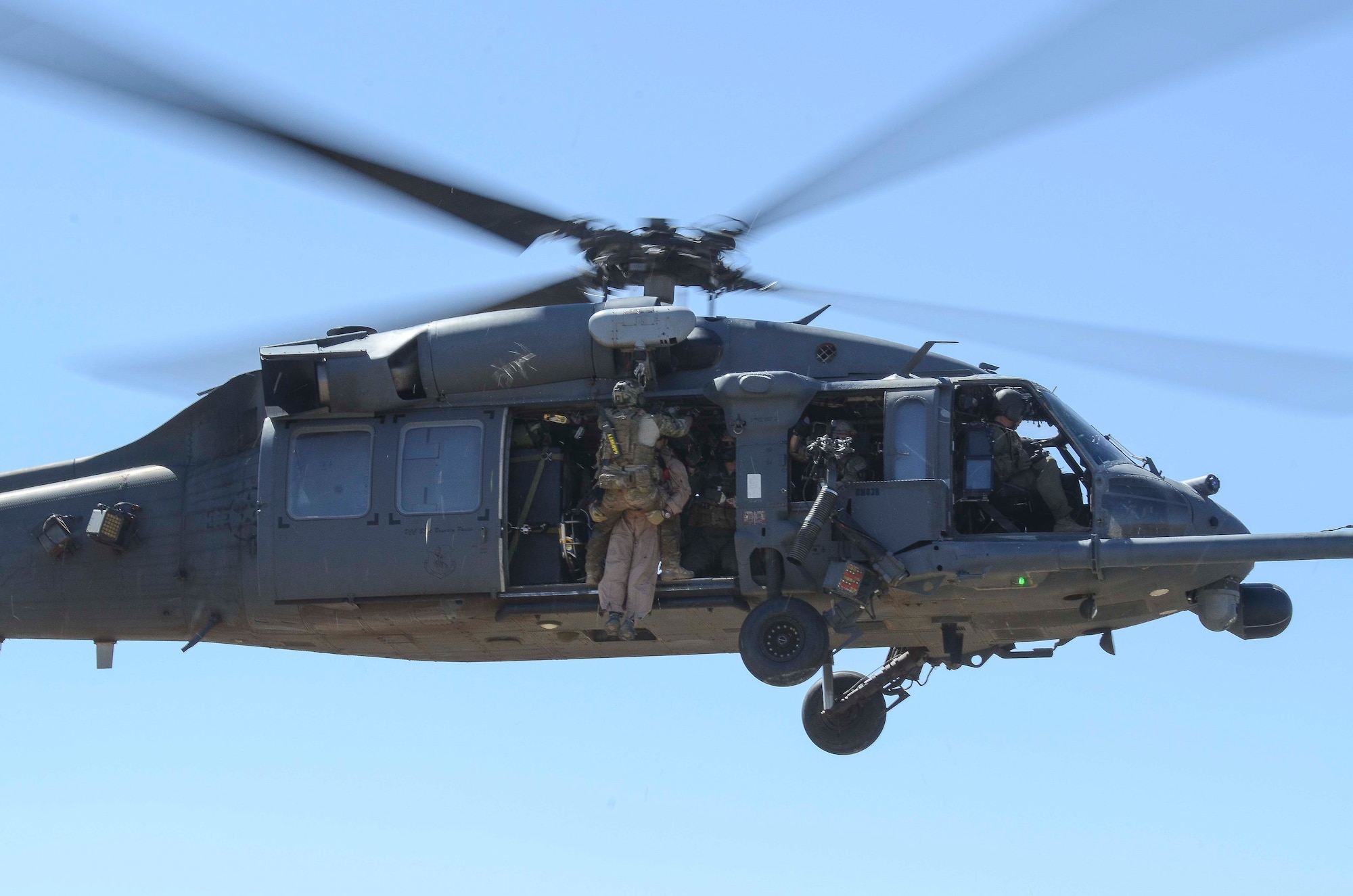 A pararescuemen hoists Maj. John Reed, 12th Air Force (Air Forces Southern) executive officer, in to a HH-60 during a Combat Search and Rescue Exercise in Southern Ariz., April 29, 2014. The main objective of this exercise was to effectively integrate communications across joint platforms to authenticate, locate and protect isolated personnel while successfully extracting them. (U.S. Air Force photo by Staff Sgt. Adam Grant/Released)