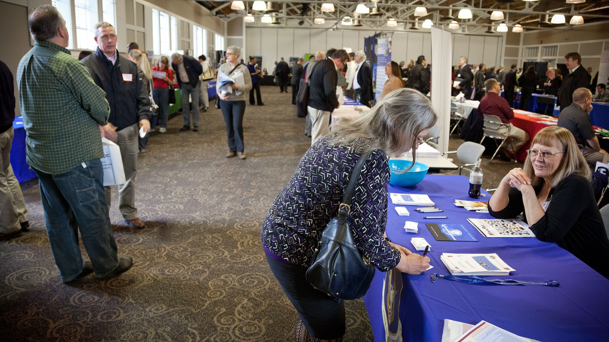 Cindy Murry (right), 934th Contracting Office contracting officer, speaks with small business owners at a trade fair sponsored by the Federal Executive Board of Minnesota in Brooklyn Park, Minn., Wednesday.  The event provides small businesses an opportunity to meet with representatives from Federal, State and local departments, commercial/prime contractors, and nonprofit organizations; and learn about upcoming contracts.  (U.S. Air Force photo by Shannon McKay/Released)