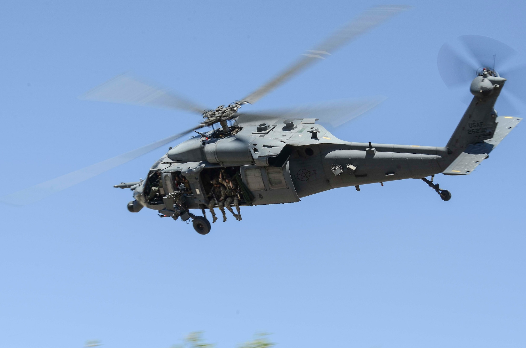 An HH-60 helicopter searches for stranded pilots during a Combat Search and Rescue Exercise in Southern Ariz., April 29, 2014. The main objective of this exercise was to effectively integrate communications across joint platforms to authenticate, locate and protect isolated personnel while successfully extracting them. (U.S. Air Force photo by Staff Sgt. Adam Grant/Released)