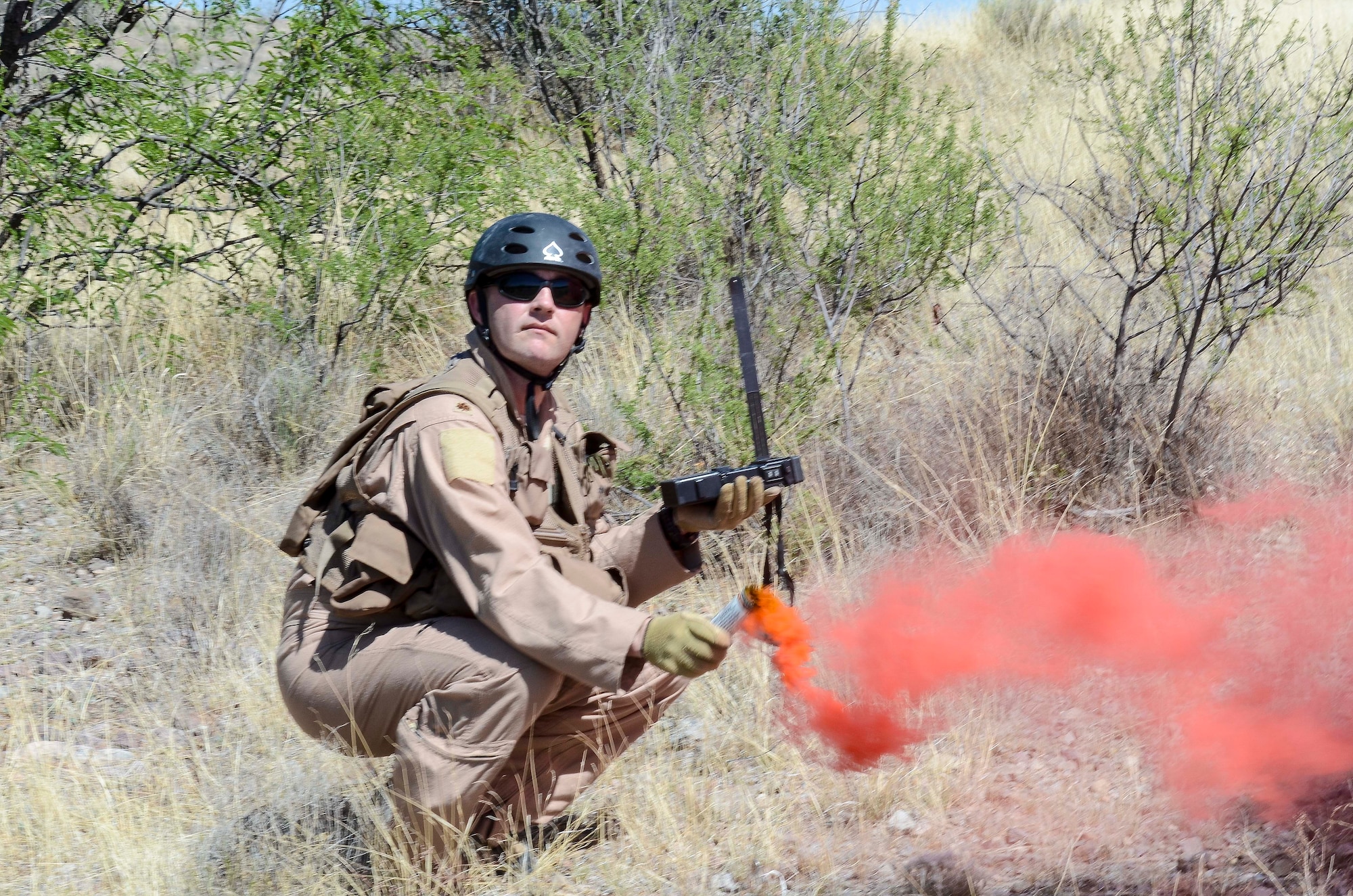 Maj. John Reed, 12th Air Force (Air Forces Southern) executive officer, uses a flare gain the attention of nearby aircraft during a Combat Search and Rescue Exercise in Southern Ariz., April 29, 2014. The main objective of this exercise was to effectively integrate communications across joint platforms to authenticate, locate and protect isolated personnel while successfully extracting them. (U.S. Air Force photo by Staff Sgt. Adam Grant/Released)