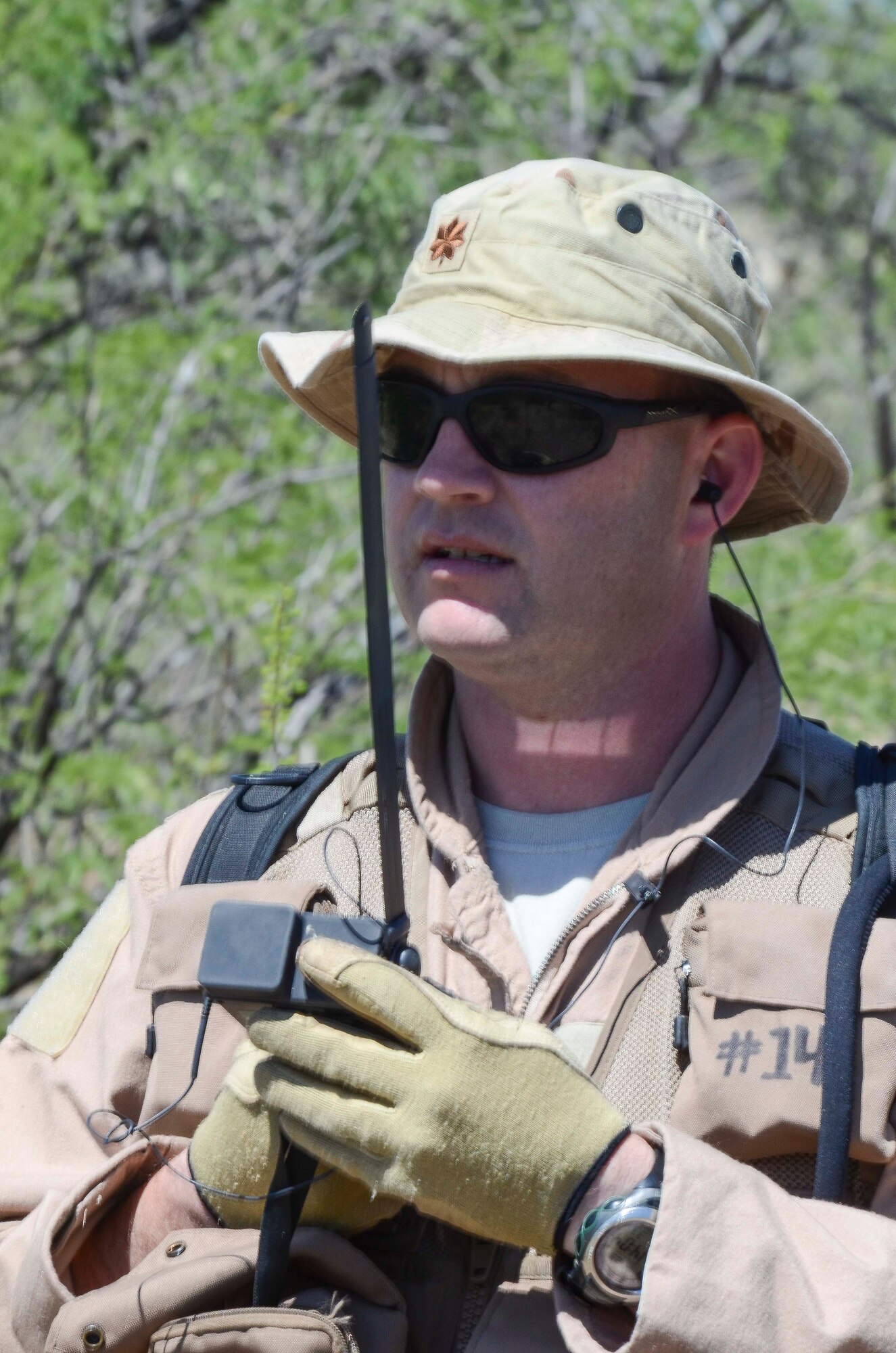 Maj. John Reed, 12th Air Force (Air Forces Southern) executive officer, radios for help during a Combat Search and Rescue Exercise in Southern Ariz., April 29, 2014. The main objective of this exercise was to effectively integrate communications across joint platforms to authenticate, locate and protect isolated personnel while successfully extracting them. (U.S. Air Force photo by Staff Sgt. Adam Grant/Released)