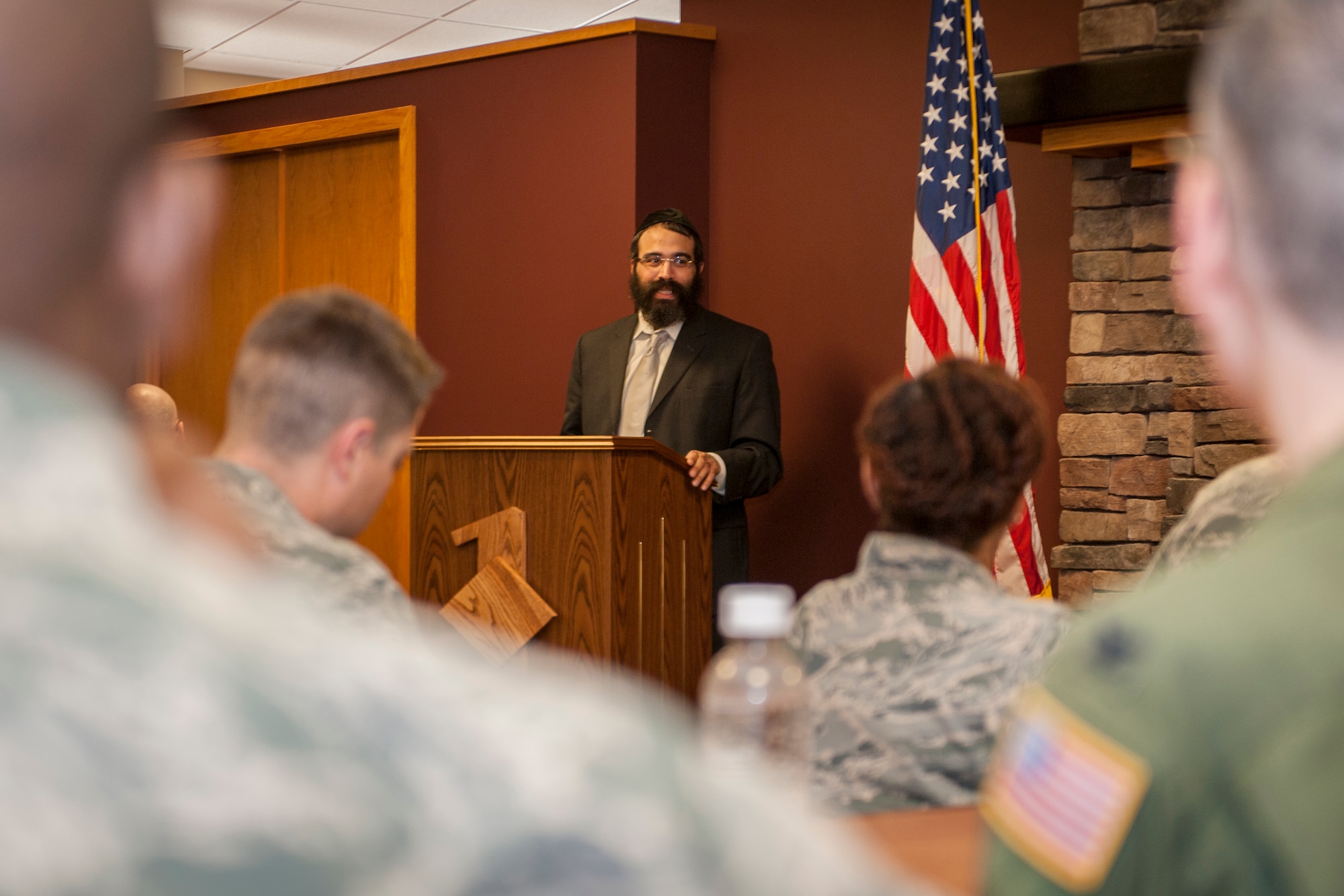 Rabbi Yisroel Hahn talks with attendees of a Holocaust remembrance breakfast in the Warrior Dining Facility at Fairchild Air Force Base, Wash., May 1, 2014. Hahn came as the guest speaker showing Airmen how they can ensure such genocide is never repeated. Hahn leads the Jewish community center in Spokane, Wash., called the Chabad Center. (U.S. Air Force photo by Staff Sgt. Benjamin W. Stratton/Released)