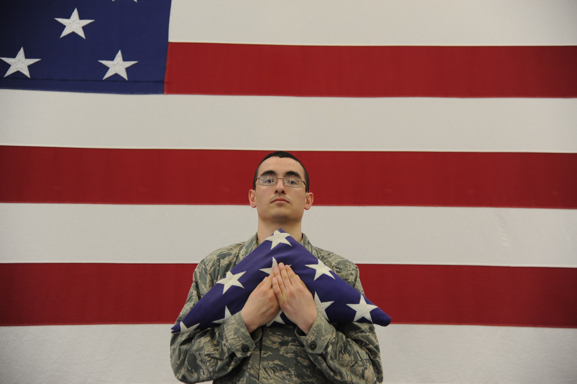 Airman 1st Class Richard Hopkins, 319th Air Base Wing Honor Guard guardsman, poses with a folded flag, on April 30, 2014 on Grand Forks Air Force Base, N.D. Hopkins is the Warrior of the Week for the final week of April. (U.S. Air Force photo/Senior Airman Zachiah Roberson)