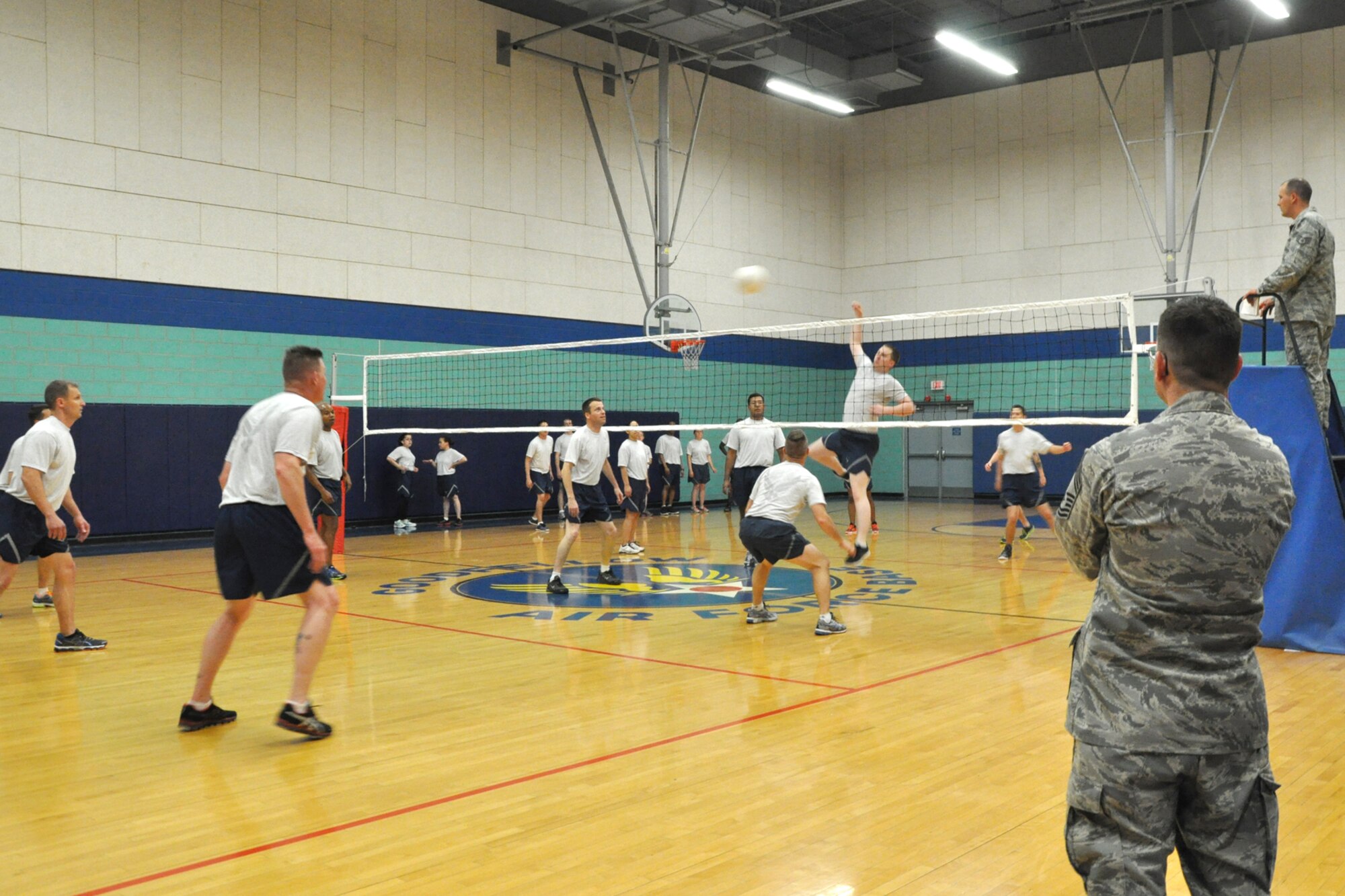 GOODFELLOW AIR FORCE BASE, Texas – Chief Master Sergeant Raymond Irizarry, 17th Training Group superintendent, watches an Airman Leadership School class member hits the ball to the eagles and chiefs’ side of the court during the volleyball match at the Mathis Fitness Center April 22. The eagles and chiefs won the volleyball matches, with two wins and one loss. (U.S. Air Force photo/ Airman 1st Class Breonna Veal)