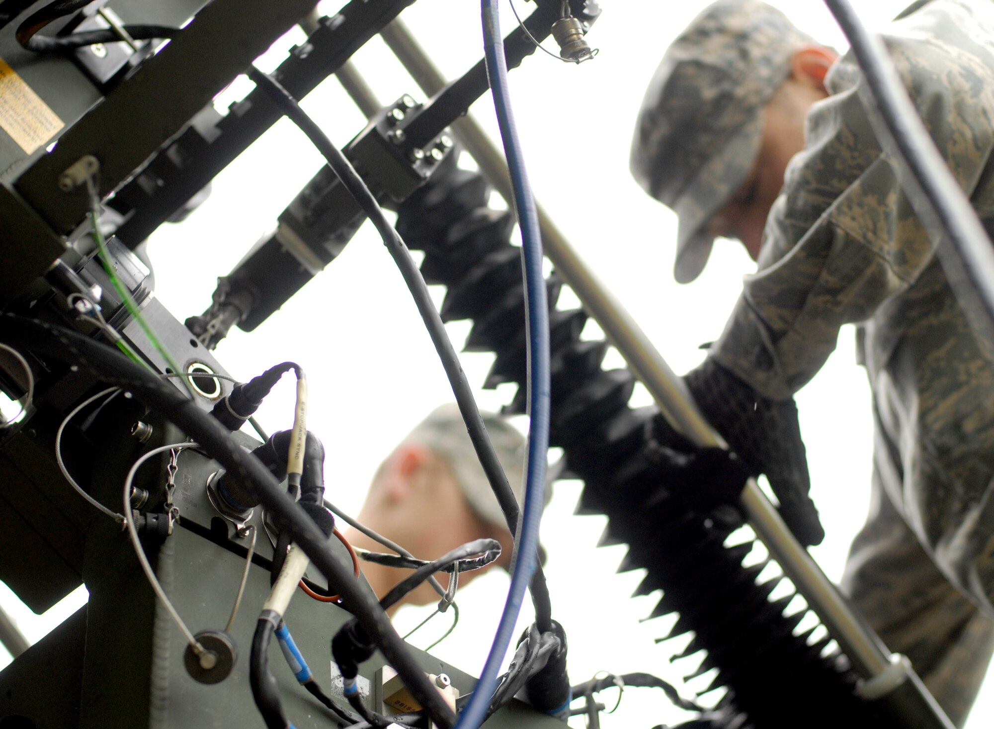 Airman 1st Class Brendan Wood (left), 607th Support Squadron transmission systems apprentice, and Senior Airman Joseph Mark Talampas, 607th SPTS transmissions radio frequencies technician, prepare a newly repaired antenna for satellite accessioning testing on Osan Air Base, Republic of Korea, April 28, 2014. The communication system was restored to full mission capability after 51st Logistics Readiness Squadron Vehicle Management Airmen and civilians applied their body shop skills to refurbishing essential petals of the antenna.  (U.S. Air Force photo / 1st Lt. Kay M. Nissen)