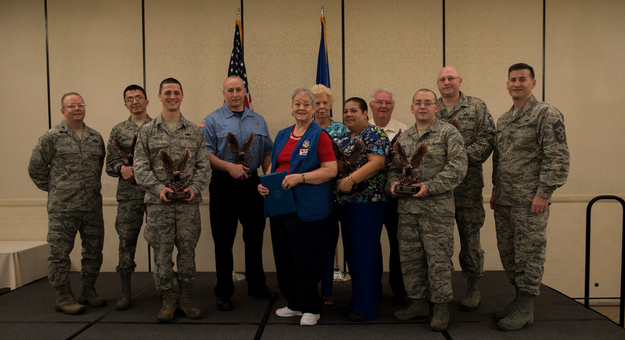 Col. Jeffrey DeVore, Joint Base Charleston commander (left), and Chief Master Sgt. Mark Bronson, 628th Air Base Wing command chief, stand with the 628th ABW Quarterly Awards winners May 1, 2014, at the Charleston Club on Joint Base Charleston – Air Base, S.C. The 628th ABW Quarterly Awards are held to recognize outstanding Airmen, noncommisioned officers, senior noncomissioned officers, company grade officers and civilians for their hard work and dedication. (U.S. Air Force photo/ Airman 1st Class Clayton Cupit)