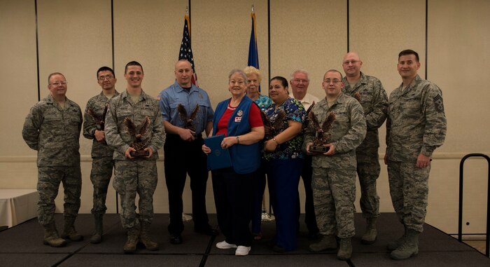 Col. Jeffrey DeVore, Joint Base Charleston commander (left), and Chief Master Sgt. Mark Bronson, 628th Air Base Wing command chief, stand with the 628th ABW Quarterly Awards winners May 1, 2014, at the Charleston Club on Joint Base Charleston – Air Base, S.C. The 628th ABW Quarterly Awards are held to recognize outstanding Airmen, noncommisioned officers, senior noncomissioned officers, company grade officers and civilians for their hard work and dedication. (U.S. Air Force photo/ Airman 1st Class Clayton Cupit)