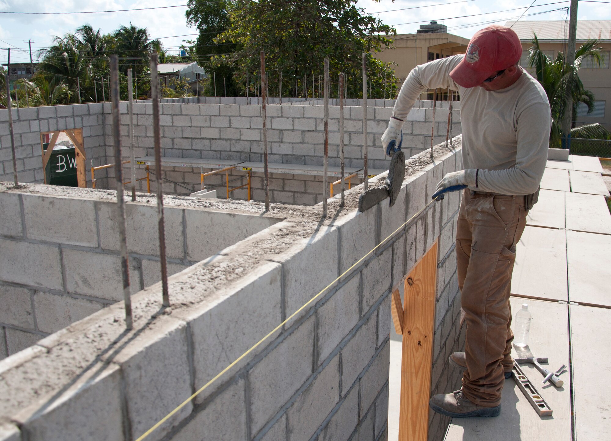 U.S. Air Force Staff Sgt. Adam Moreau, New Horizons civil engineer deployed from the 820th RED HORSE Squadron at Nellis Air Force Base, Nev., prepares mortar for laying blocks April 24, 2014, at the Sadie Vernon Technical High School construction site in Belize City, Belize. Belize Defence Force and U.S. service members are working together to build five school buildings and one medical facility throughout Belize during New Horizons Belize 2014. New Horizons is an annual event coordinated between the U.S. and the host nation to provide mutual training opportunities. (U.S. Air Force photo by Tech. Sgt. Kali L. Gradishar/Released)