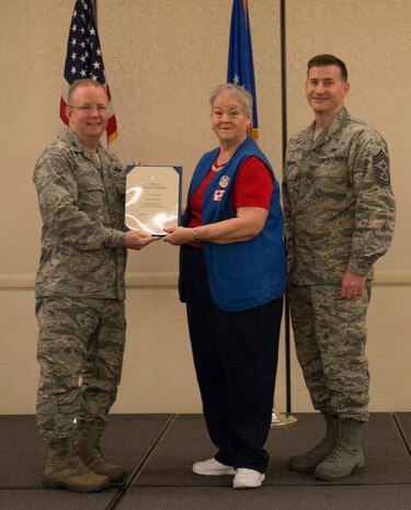 Col. Jeffrey DeVore, Joint Base Charleston commander (left), and Chief Master Sgt. Mark Bronson, 628th Air Base Wing command chief, present the Volunteer Excellence Award to Regina Gardner May 1, 2014, at the Charleston Club on Joint Base Charleston – Air Base, S.C. The 628th ABW Quarterly Awards are held to recognize outstanding Airmen, noncommisioned officers, senior noncomissioned officers, company grade officers and civilians for their hard work and dedication. (U.S. Air Force photo/ Airman 1st Class Clayton Cupit)