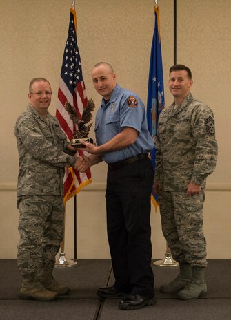 Col. Jeffrey DeVore, Joint Base Charleston commander (left), and Chief Master Sgt. Mark Bronson, 628th Air Base Wing command chief, present the Category I Civilian of the Quarter Award to Matthew Coleman from the 628th Civil Engineer Squadron May 1, 2014, at the Charleston Club on Joint Base Charleston – Air Base, S.C. The 628th ABW Quarterly Awards are held to recognize outstanding Airmen, noncommisioned officers, senior noncomissioned officers, company grade officers and civilians for their hard work and dedication. (U.S. Air Force photo/ Airman 1st Class Clayton Cupit)