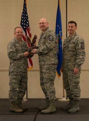 Col. Jeffrey DeVore, Joint Base Charleston commander (left), and Chief Master Sgt. Mark Bronson, 628th Air Base Wing command chief, present the Senior Noncommissioned Officer of the Quarter to Master Sgt. Patrick Easterling from the 628th Civil Engineer Squadron May 1, 2014, at the Charleston Club on Joint Base Charleston – Air Base, S.C. The 628th ABW Quarterly Awards are held to recognize outstanding Airmen, noncommisioned officers, senior noncomissioned officers, company grade officers and civilians for their hard work and dedication. (U.S. Air Force photo/ Airman 1st Class Clayton Cupit)