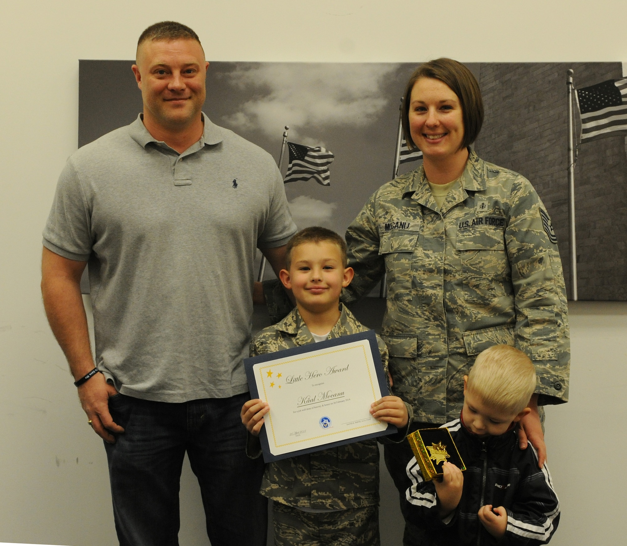 The Mocanu family poses for a photo after Käal received a Hero Award at the Military & Family Support Center on Joint Base Andrews, Md., April 24. Käal received the award for his actions when his father collapsed in their home on Feb. 26, 2014. (U.S. Air Force photo/Airman 1st Class Ryan J. Sonnier)