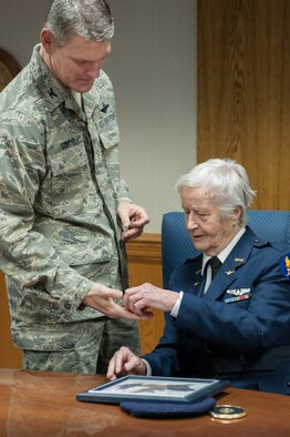 Col. Barry Gorter, commander of the 123rd Airlift Wing, presents Florence Shutsy Reynolds, 91, a former member of the Women Airforce Service Pilots corps during World War II, with a wing coin and certificate identifying her as an Honorary Wing Commander during her visit to the Kentucky Air National Guard Base in Louisville, Ky., March 22, 2014. The WASP program’s primary focus was to reassign responsibility for flight operations over the United States from male to female pilots, freeing men to go to war. (U.S. Air National Guard photo by Staff Sgt. Vicky Spesard)