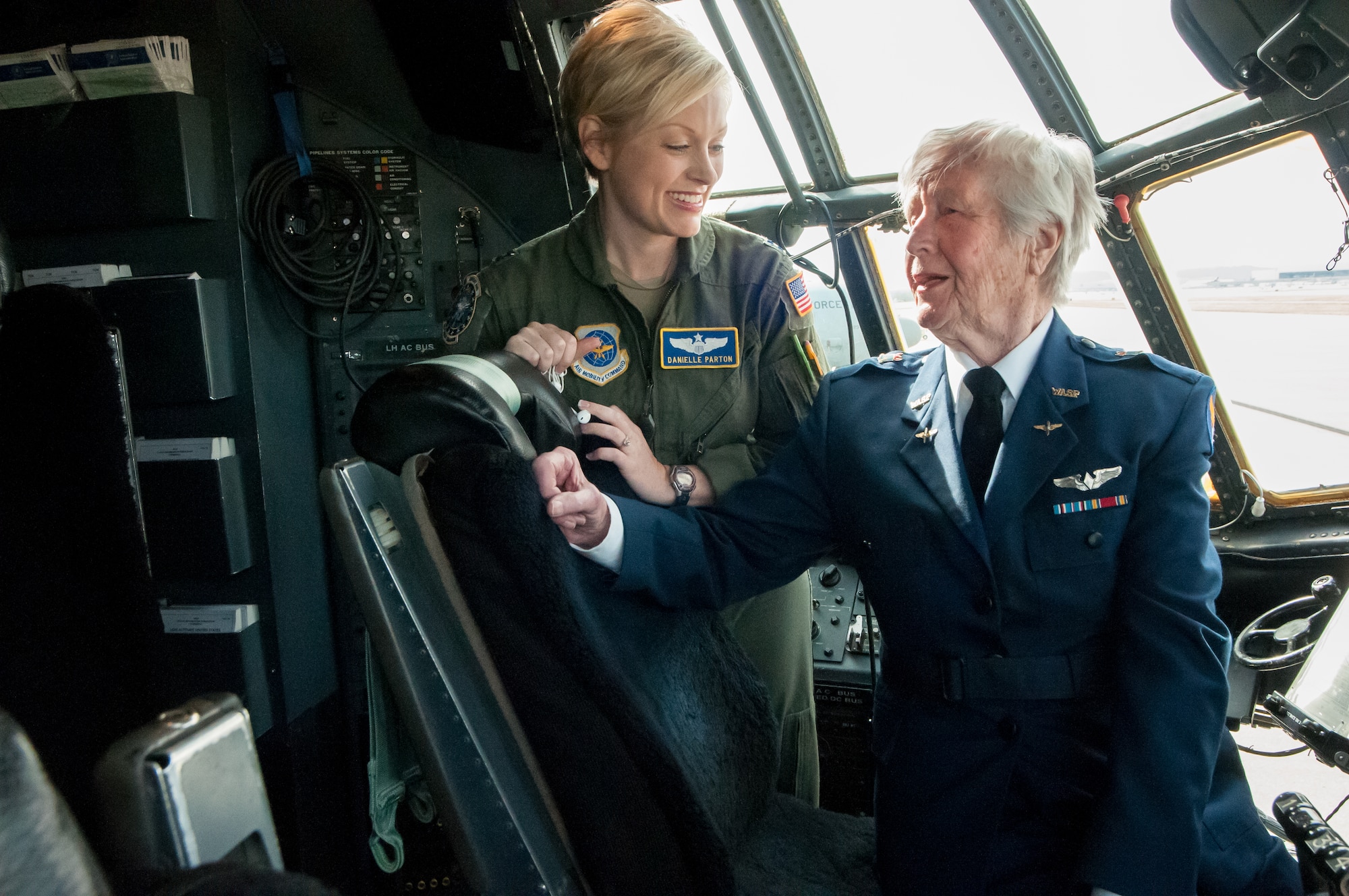 Capt. Danielle Parton, a pilot in the 123rd Airlift Wing, shares flying stories with Florence Shutsy Reynolds on the flight deck of a C-130 aircraft at the Kentucky Air National Guard Base in Louisville, Ky., March 22, 2014. Reynolds was a pilot in the Women Airforce Service Pilots corps during World War II. (U.S. Air National Guard photo by Staff Sgt. Vicky Spesard)