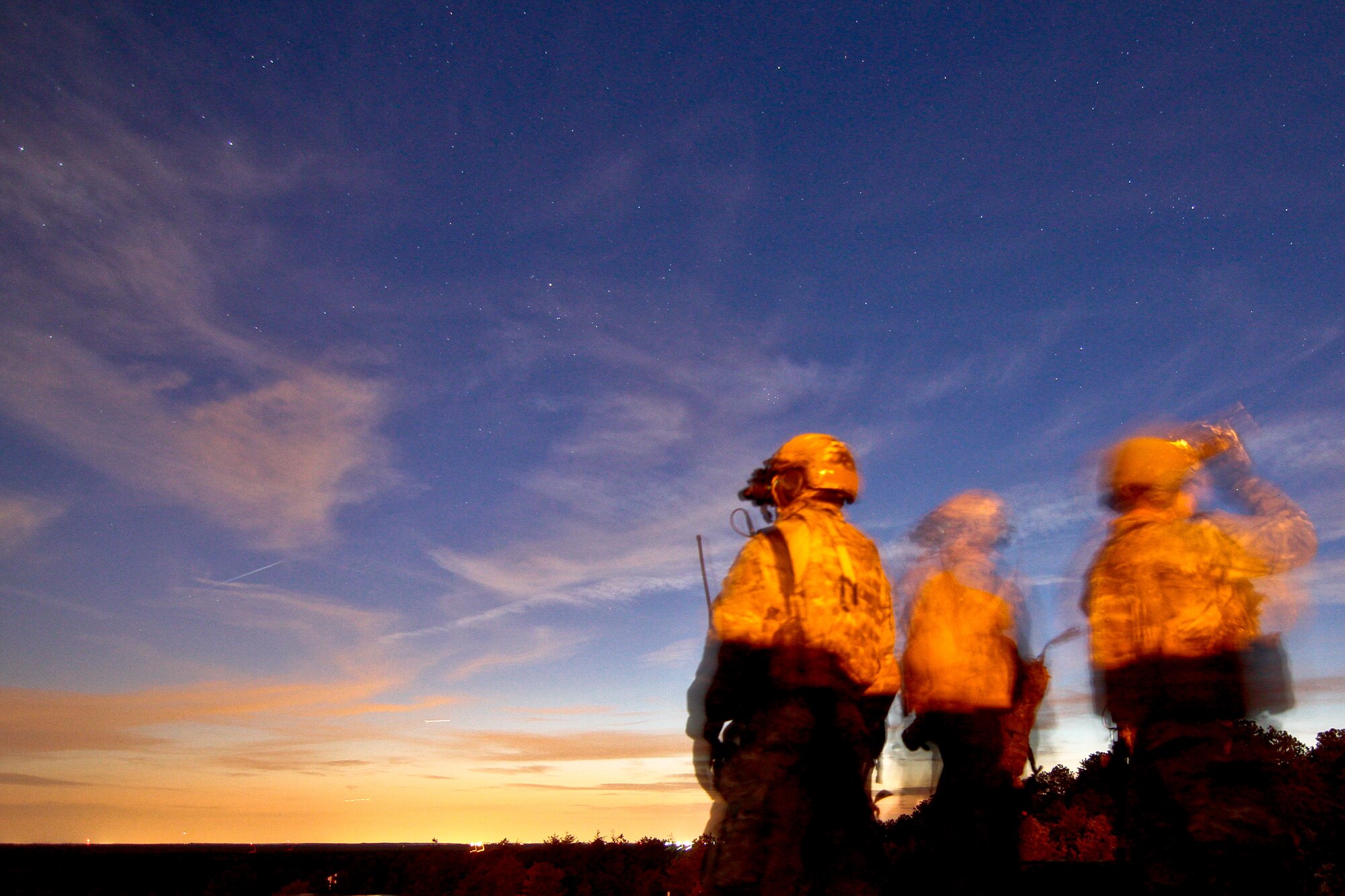 A picture of U.S. Air Force tactical air control party airmen from the New Jersey Air National Guard's 227th Air Support Operations Squadron marking targets for a U.S. Marine Corps AH-1W Super Cobra.