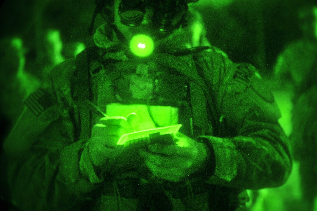 A U.S. Air Force tactrical air control party airman from the New Jersey Air National Guard's 227th Air Support Operations Squadron goes over grid coordinates on April 10, 2014, at Fort Dix, N.J.  The New Jersey Army and Air National Guardsmen took part in a joint training exercise with the U.S. Marine Corps. (U.S. Air National Guard photo by Tech. Sgt. Matt Hecht/Released)