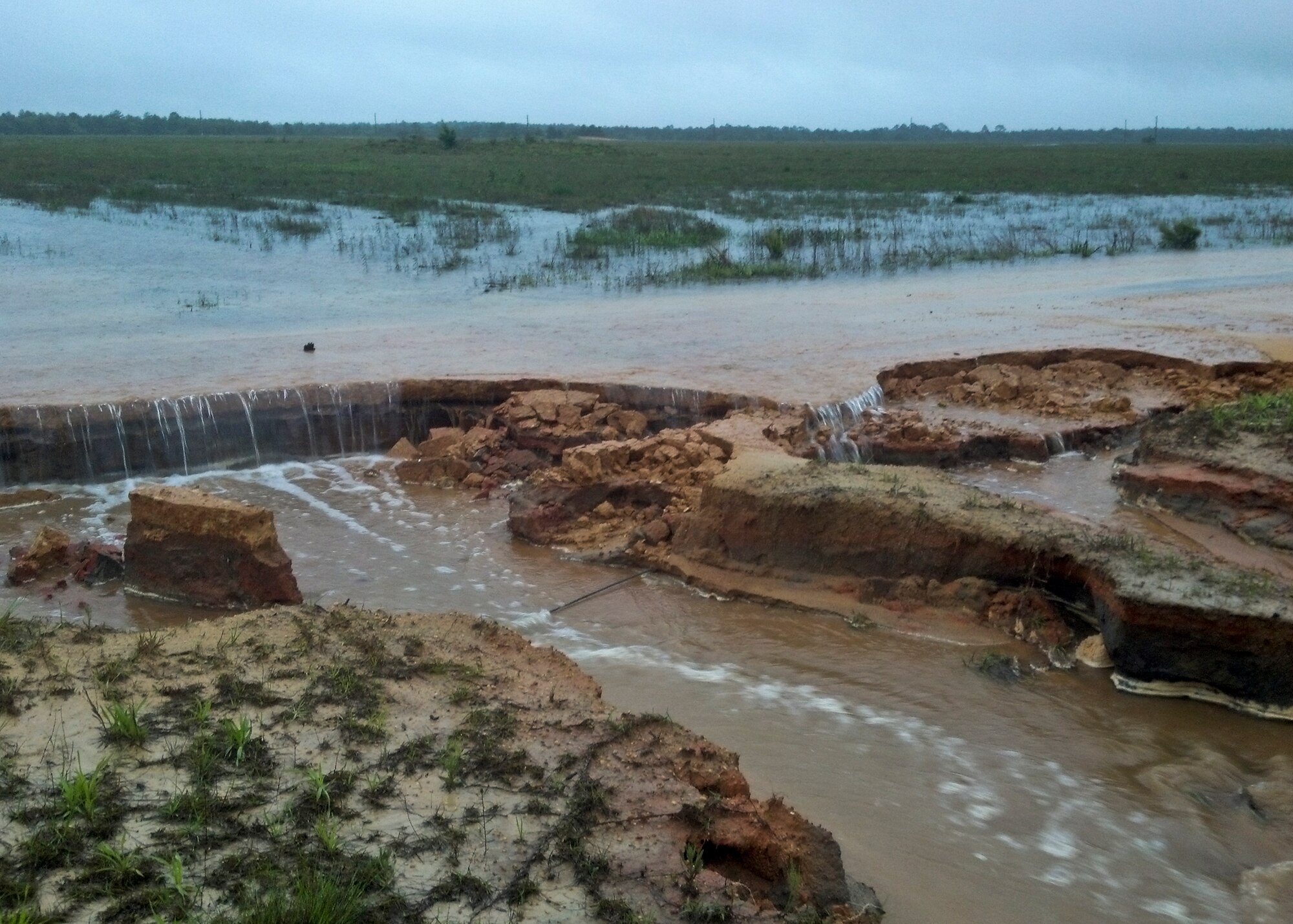 Flood waters wash out and break down a road on the Eglin Air Force Base range May 1.  Eglin was drenched with more than 10 inches of rain April 29-30 for a total of 18.28 inches for the month.  Most of the damage sustained on Eglin was to its miles of range roads.  (Courtesy photo)