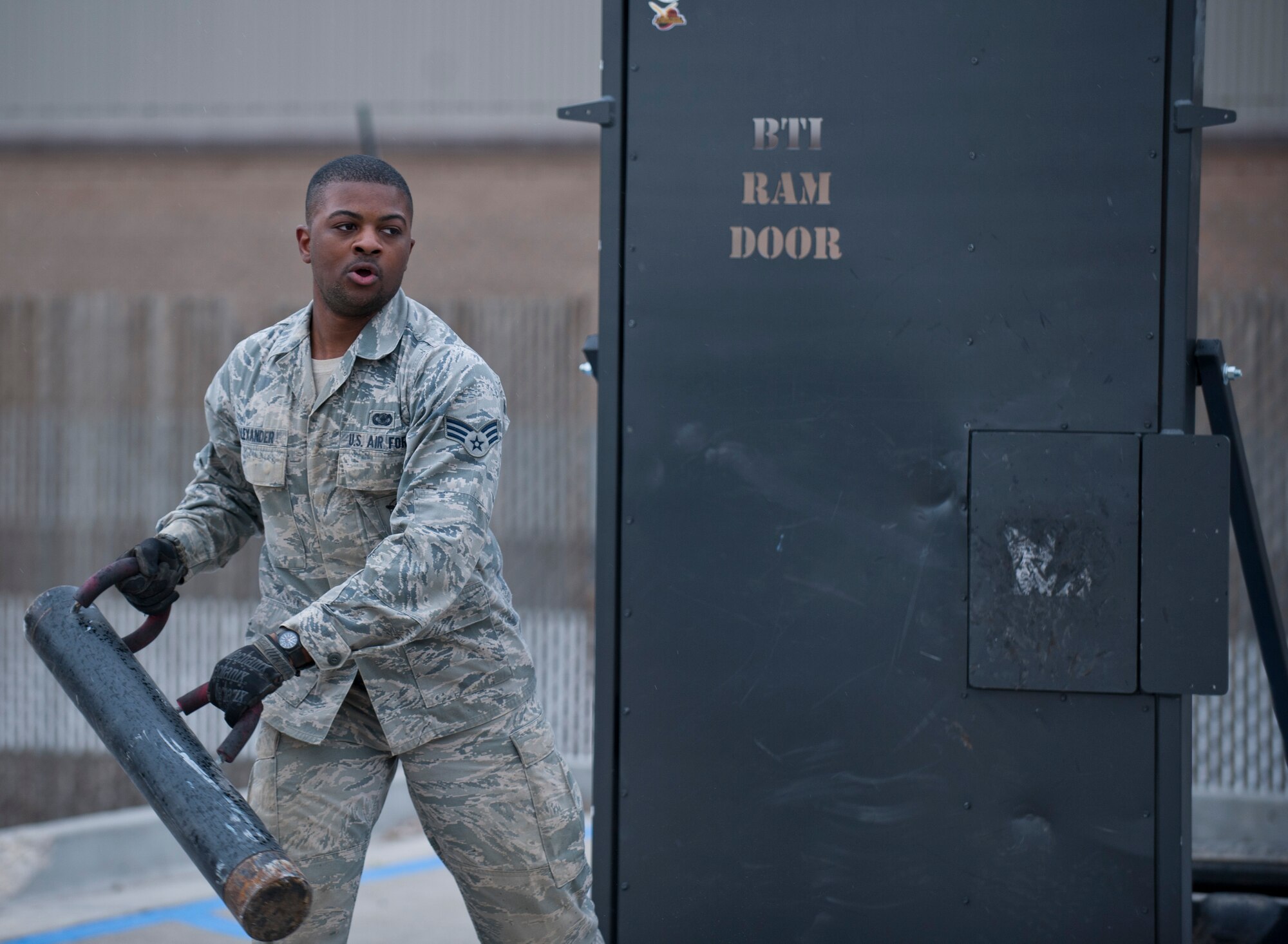 Senior Airman Jahvaun Alexander, 366th Security Forces Squadron staff armorer, swings a battering ram at a door, April 22, 2014, at Mountain Home Air Force Base, Idaho. After 11 obstacles Airmen were faced with knocking open the breaching door, which signified the completion of the Defenders Edge Resiliency Challenge. (U.S. Air Force Photo by Airman 1st Class Brittany A. Chase/Released)