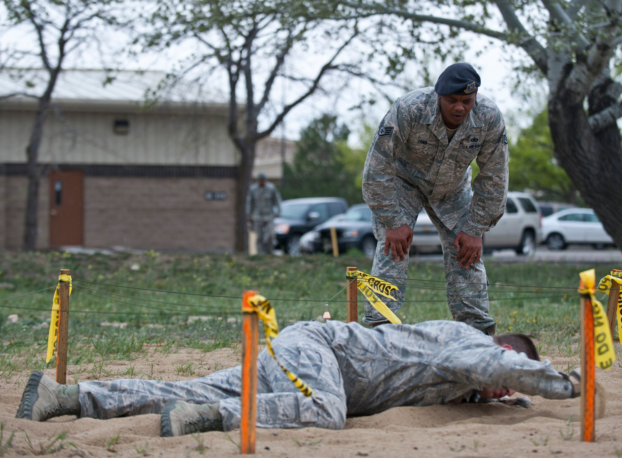 Staff Sgt. Richard Swanson, 366th Security Forces Squadron flight S30A2 response force leader, low crawls under wire, April 22, 2014, at Mountain Home Air Force Base, Idaho. The Defenders Edge Resiliency Challenge course consisted of 12 obstacles to help build confidence and team building within Airmen and resiliency. (U.S. Air Force Photo by Airman 1st Class Brittany A. Chase/Released)