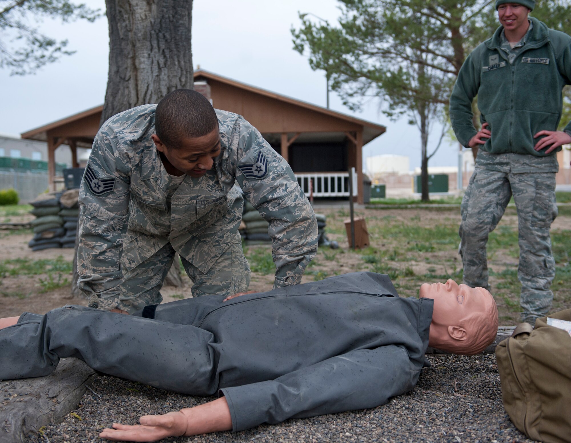 Staff Sgt. Rowdy Spears, 366th Security Forces Squadron flight S30A2 response force leader, examines a rescue dummy, April 22, 2014, at Mountain Home Air Force Base, Idaho. Spears was given a scenario in which the dummy suffered an injury, he then had to assess the situation and explain how to give proper medical attention. (U.S. Air Force Photo by Airman 1st Class Brittany A. Chase/Released)