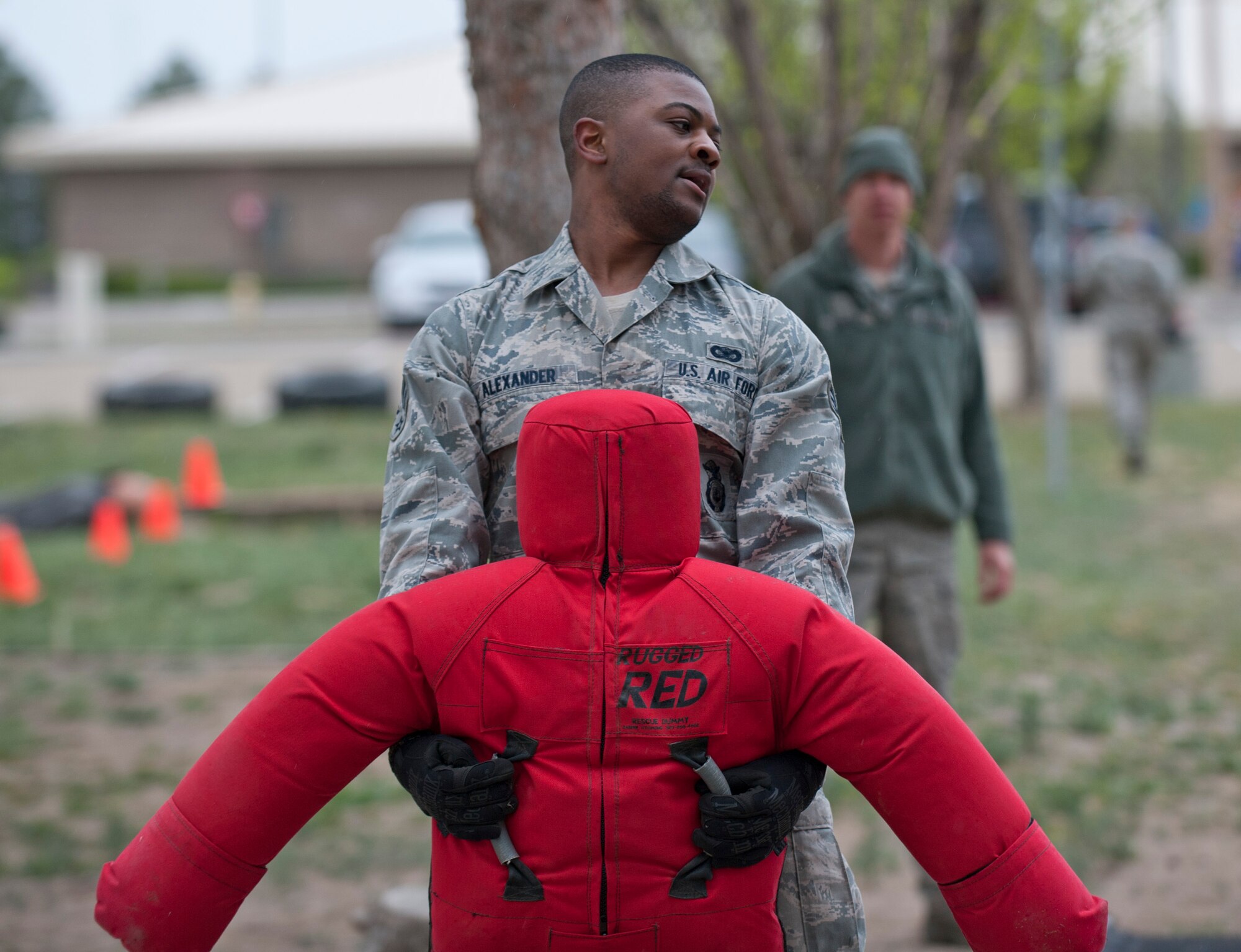 Senior Airman Jahvaun Alexander, 366th Security Forces Squadron staff armorer, carries two ammunition cans, April 22, 2014, at Mountain Home Air Force Base, Idaho. The Defenders Edge Resiliency Challenge course consisted of 12 obstacles to help build confidence within Airmen and promote team building and resiliency. (U.S. Air Force Photo by Airman 1st Class Brittany A. Chase/Released)