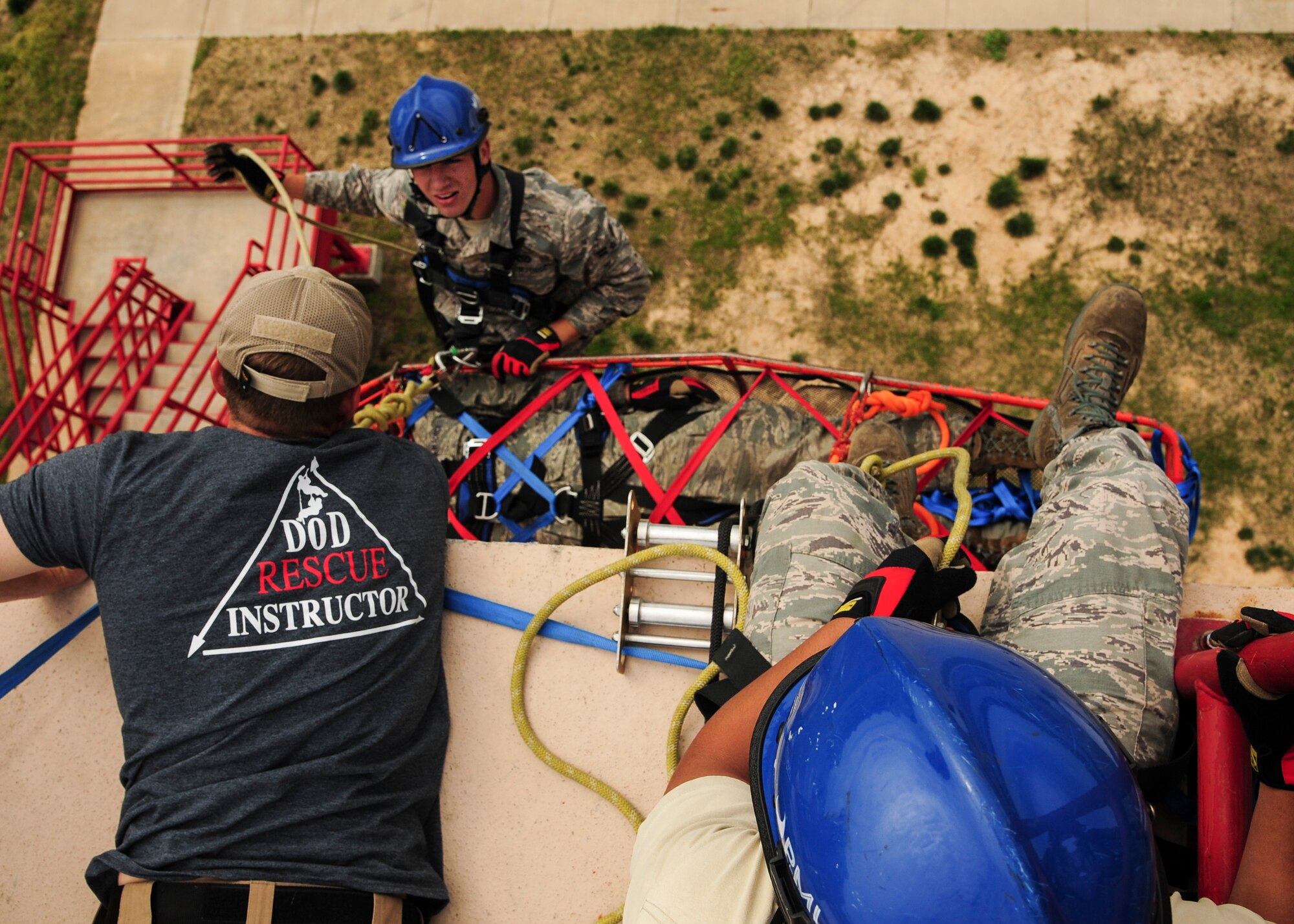 A rescue instructor from the 312th Airlift Squadron civil engineer fire department trains Airmen from the 19th Airlift Wing civil engineer fire department April 18, 2014, Jacksonville, Ark. The Airmen practiced proper rappelling techniques as well as basket carries. (U.S. Air Force photo by Airman 1st Class Harry Brexel)