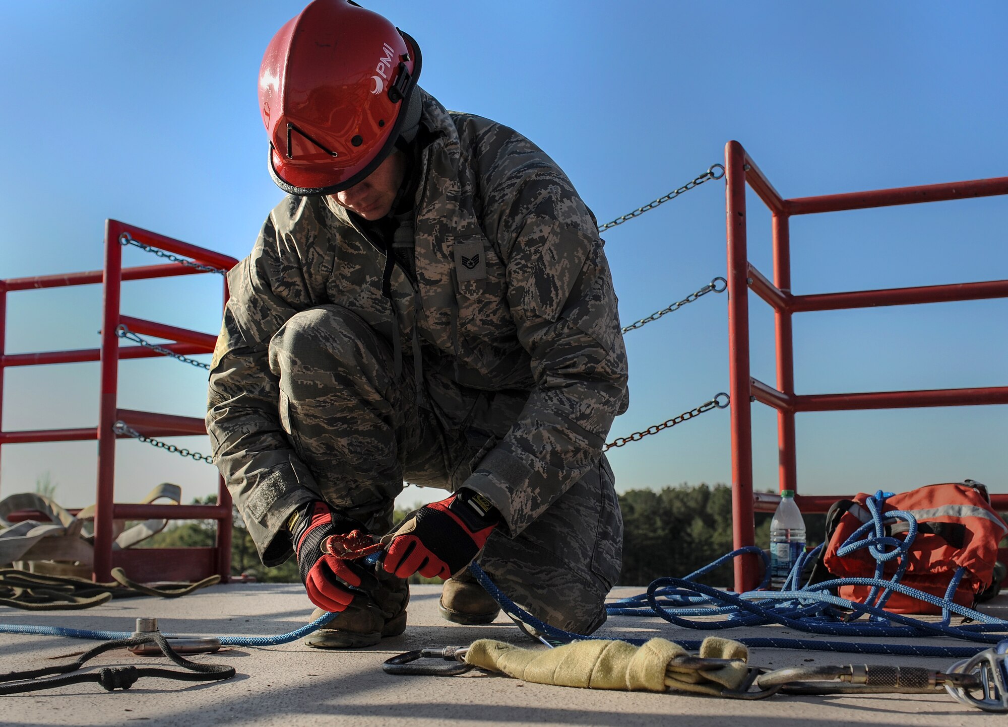 A firefighter from the 19th Civil Engineer Squadron prepares a belay system during a fire rescue technician course April 16, 2014, at Jacksonville, Ark. The belay system is used to create a safety mechanism for firefighters when rappelling down buildings. (U.S. Air Force photo by Staff Sgt. Jessica Condit)