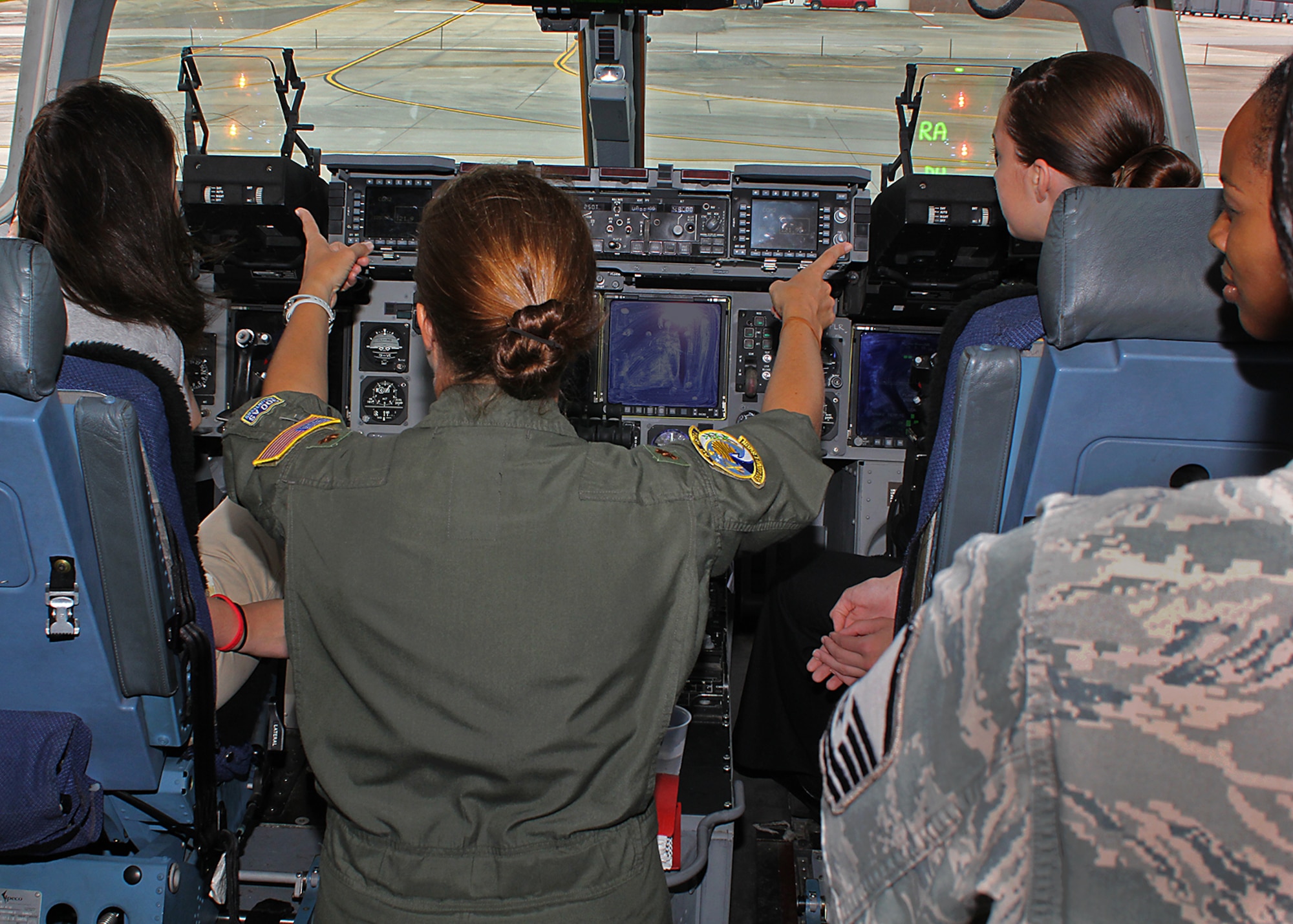 Maj. Ruth Meloeny, 300th Airlift Squadron pilot, describes the instrumentation on the flight deck of a C-17 Globemaster III during the Joint Base Charleston Women in Aviation Career Day April 29. About 90 8th and 9th-grade girls from Charleston area schools visited base to learn about jobs in aviation and meet successful women in aviation career field. (U.S. Air Force photo by Michael Dukes)