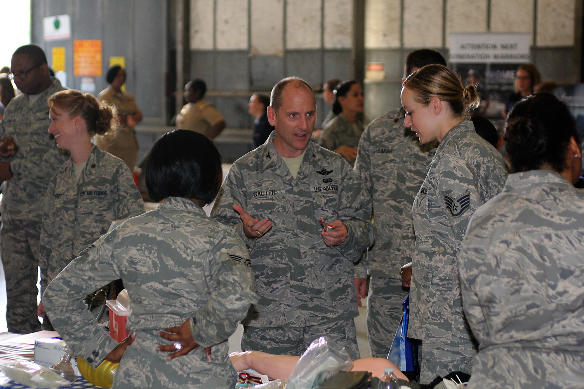 315th Airlift Wing Commander Col. Scott Sauter visits the medical career table and speaks with Staff Sgt. Melanie Frederick, 315th Aerospace Medicine Squadron, during the Joint Base Charleston Women in Aviation Career Day April 29. About 90 8th and 9th-grade girls from Charleston area schools visited base to learn about jobs in aviation and meet successful women in aviation career field. (U.S. Air Force photo by Michael Dukes)