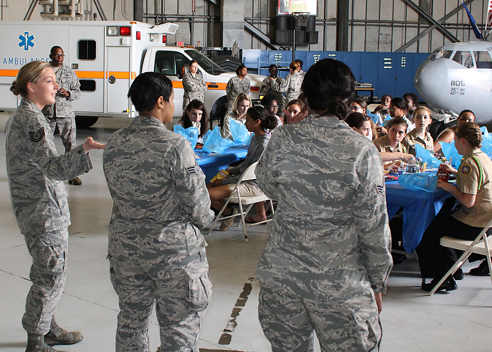 (From left) Tech. Sgt. Samantha Safford, Senior Airman Jessica Cherry, and Senior Airman Shawana Porter, from the 315th Aeromedical Evacuation Squadron, describe what it’s like to me an aeromedical technician flying on C-17 Globemaster IIIs to Charleston area teenage women attending the Joint Base Charleston Women in Aviation Career Day April 29. About 90 8th and 9th-grade girls from Charleston area schools visited base to learn about jobs in aviation and meet successful women in aviation career field. (U.S. Air Force photo by Michael Dukes)
