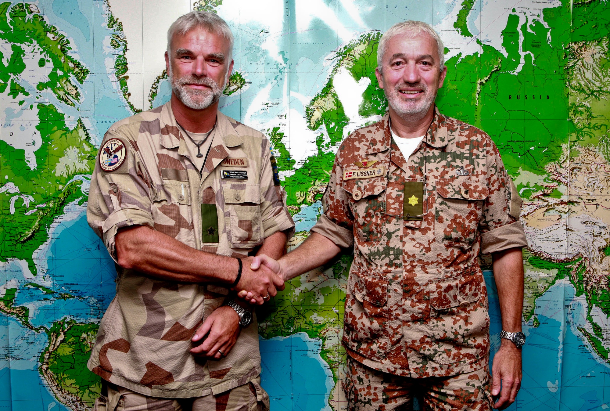 Swedish Rear Adm. Mats Fogelmark shakes hands with Danish Brig. Gen. Frank Lissner at MacDill Air Force Base, Fla., April 30, 2014. Lissner will succeed Fogelmark as chairman of the Coalition at Headquarters U.S. Central Command. (U.S. Marine Corps photo by Sgt. Fredrick J. Coleman/Released)