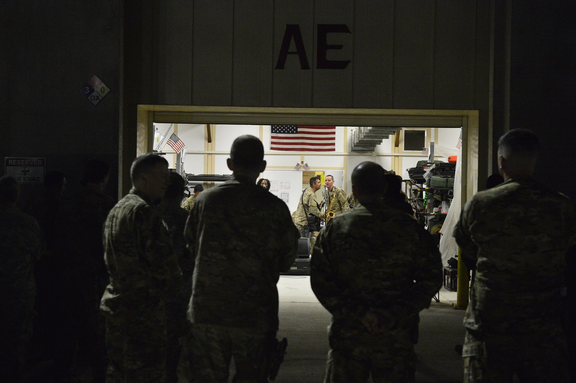 Members of the 455th Expeditionary Aeromedical Evacuation Squadron watch the Air Forces Central Command Band, Hypersonic, perform at Bagram Air Base April 11, 2014. The performance was a display of gratitude for men and women of the 455 EAES and the work they do saving lives throughout the region. (U.S. Air Force photo/Staff Sgt. Vernon Young)