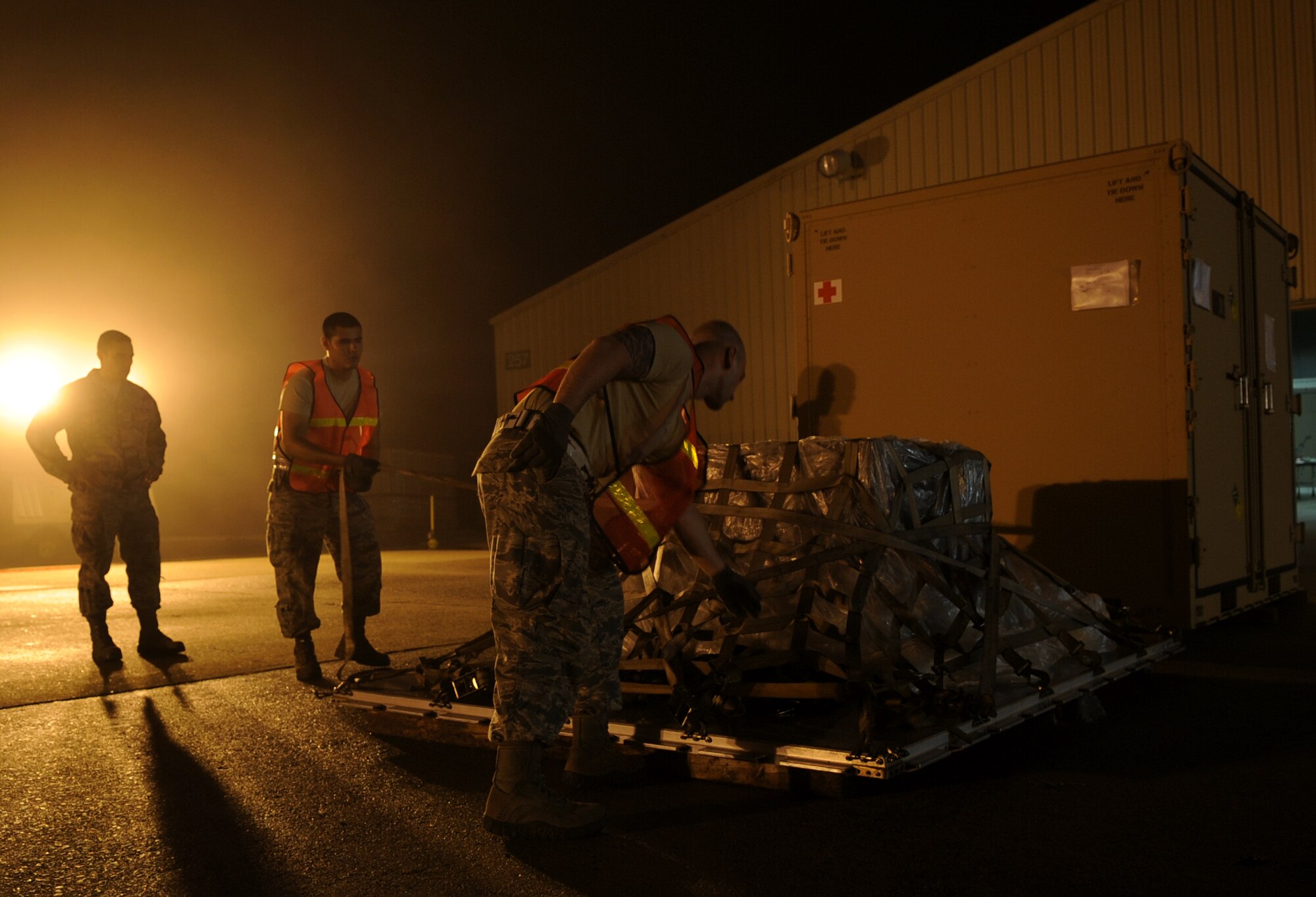 Members of the 19th Logistics Readiness Squadron tighten straps on a cargo pallet during a RockEx April 22, 2014, at Little Rock Air Force Base, Ark. The 19th LRS cargo section inspects all the cargo prior to loading to ensure safe transport. (U.S. Air Force photo by Staff Sgt. Caleb Pierce)