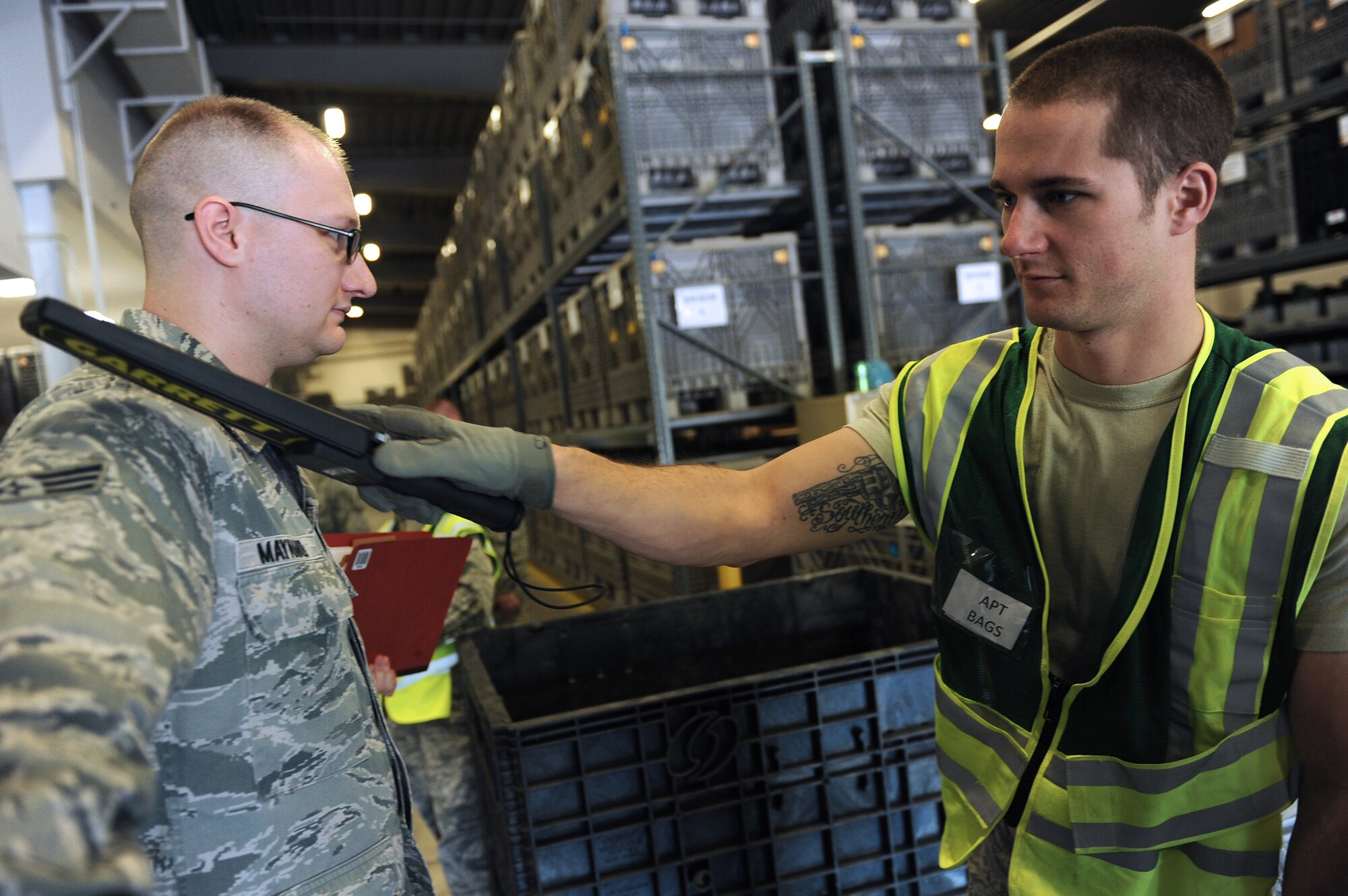 Senior Airman Seth Hamilton, a 19th Logistics Readiness Squadron air transportation journeyman, sweeps a Garrett metal detector across Senior Airman Joshua Maynard, a 19th Communications Squadron cyber transport technician, April 23, 2014, at Little Rock Air Force Base, Ark. Hamilton ensured that unauthorized material did not enter restricted areas during a RockEx. (U.S. Air Force photo by Tech. Sgt. Chad Chisholm)