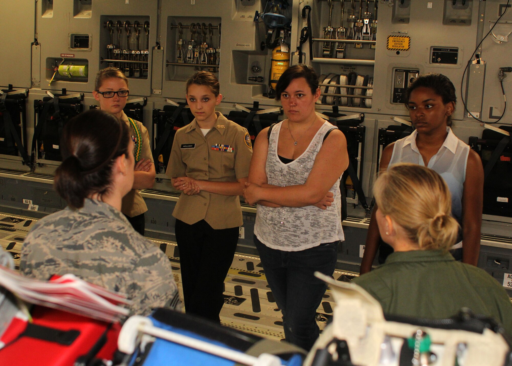 315th Aeromedical Evacuation Squadron members explain their mission of being a hospital in the sky to Charleston area teenage women aboard a  C-17 Globemaster III during the Joint Base Charleston Women in Aviation Career Day April 29. About 90 8th and 9th-grade girls from Charleston area schools visited base to learn about jobs in aviation and meet successful women in aviation career field. (U.S. Air Force photo by Michael Dukes)