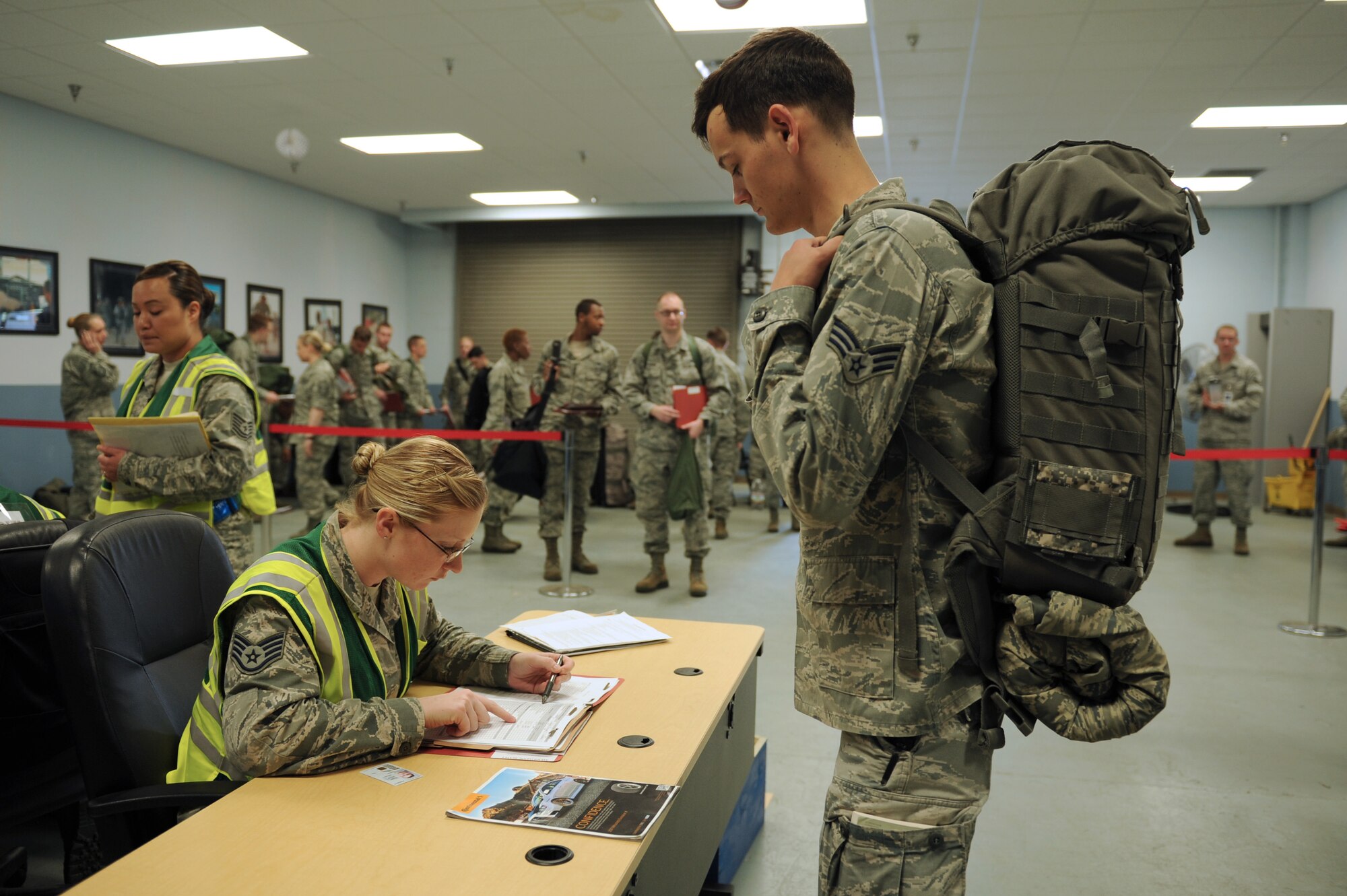 Senior Airman Scott Merriman, a 19th Communications Squadron airfield systems technician, waits for his records to be checked by Staff Sgt. Samantha Roman, a 19th Force Support Squadron adverse actions non commissioned officer in charge, April 22, 2014, at Little Rock Air Force Base, Ark.  Roman verified that deployers records were completed and up-to-date for the mock deployment during RockEx. (U.S. Air Force photo by Tech. Sgt. Chad Chisholm)