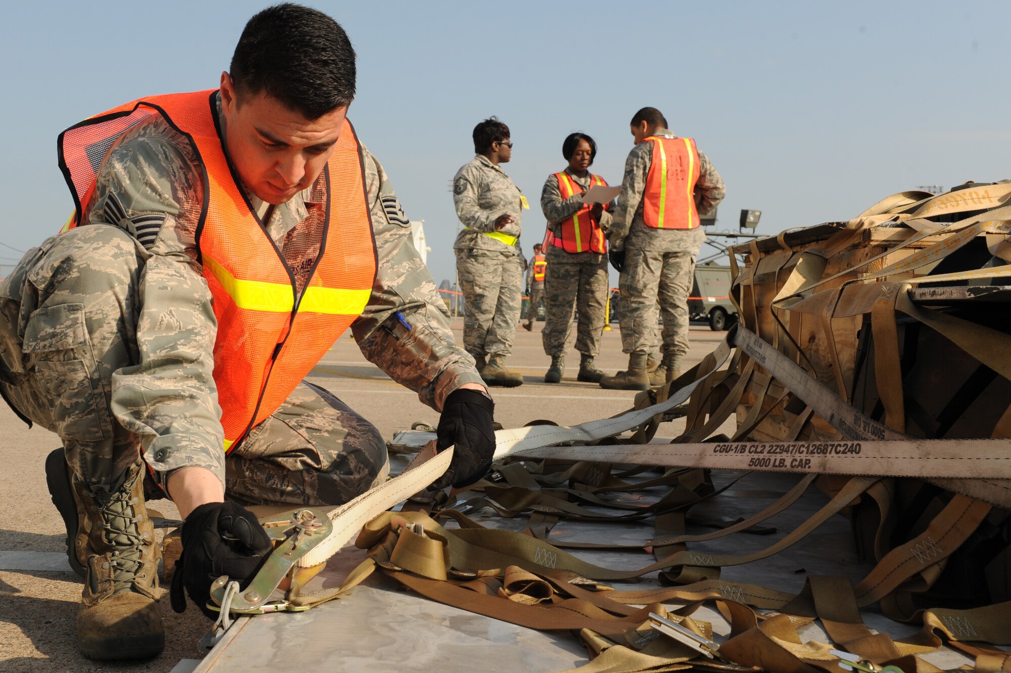 Staff Sgt. Charles Garcia, a 19th Logistics Readiness Squadron aircraft supervisor, tightens a cargo strap to a piece of simulated airfreight during a RockEx, April 22, 2014, at Little Rock Air Force Base, Ark. Garcia strapped down the piece of cargo with a CGU-1/B cargo strap rated to hold 5000 pounds. (U.S. Air Force photo by Tech. Sgt. Chad Chisholm)