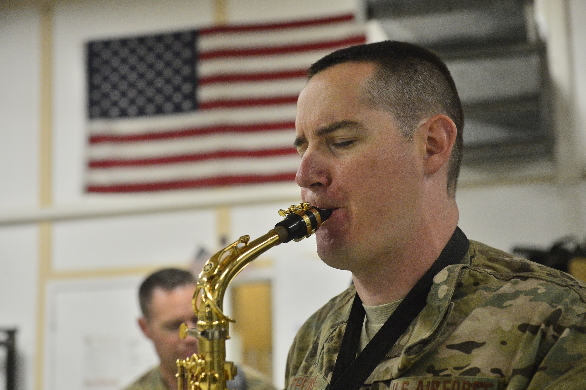U.S. Air Force Senior Airman Gregory Pflugh solos with the U.S. Air Forces Central Command Band, Hypersonic, in a performance for the 455 Expeditionary Aeromedical Evacuation Squadron at Bagram Air Base April 11, 2014. The performance was a display of gratitude for the men and women of the 455 EAES and the work they do saving lives throughout the region. (U.S. Air Force photo/Staff Sgt. Vernon Young)