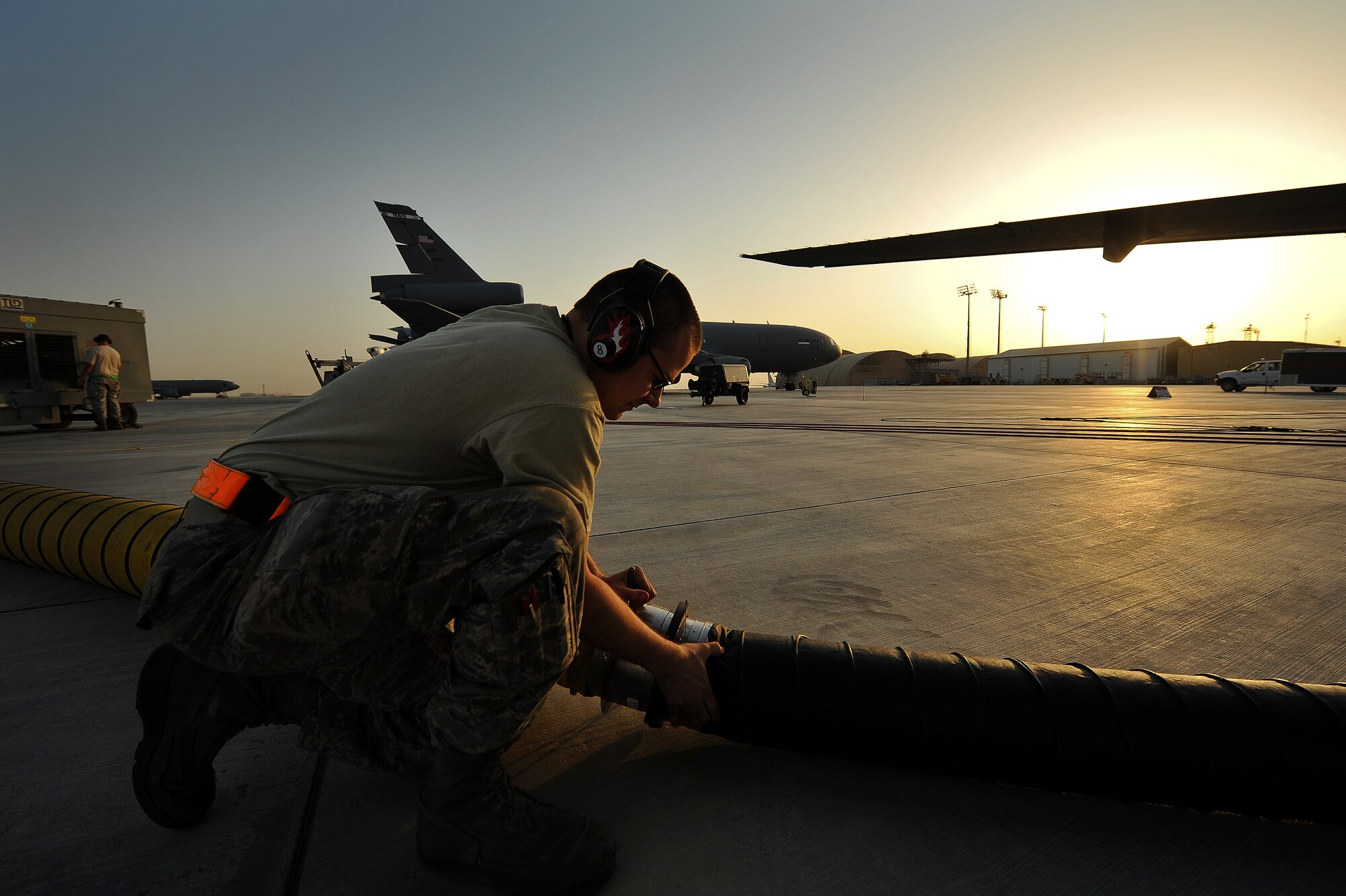 Senior Airman Donovan Balthazor, a 380th Expeditionary Maintenance Group crew chief, connects a ventilation duct to an air conditioning cart April 28, 2014, at an undisclosed location in Southwest Asia. The system ensures proper ventilation for open tank maintenance operations.  (U.S. Air Force photo byTech. Sgt. Russ Scalf/Released)
