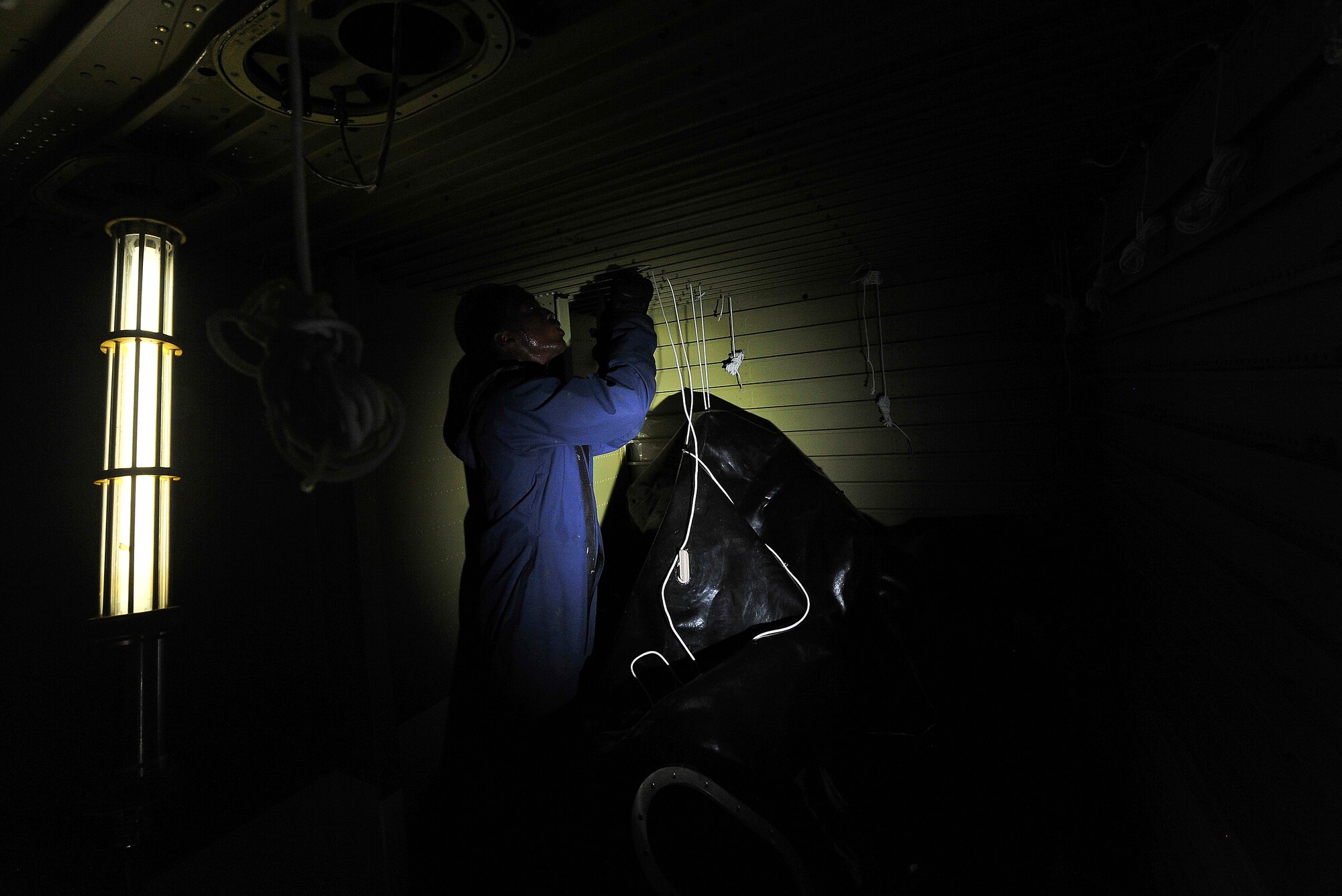 Senior Airman Tyree Bishop, a 380th Expeditionary Aircraft Maintenance Squadron fuel systems journeyman, laces a new bladder cell into a KC-10 Extender April 28, 2014, at an undisclosed location in Southwest Asia. The aerial refueling capability of the KC-10 Extender allows other aircraft to remain in battle spaces for prolonged duration sorties.(U.S. Air Force photo byTech. Sgt. Russ Scalf/Released)