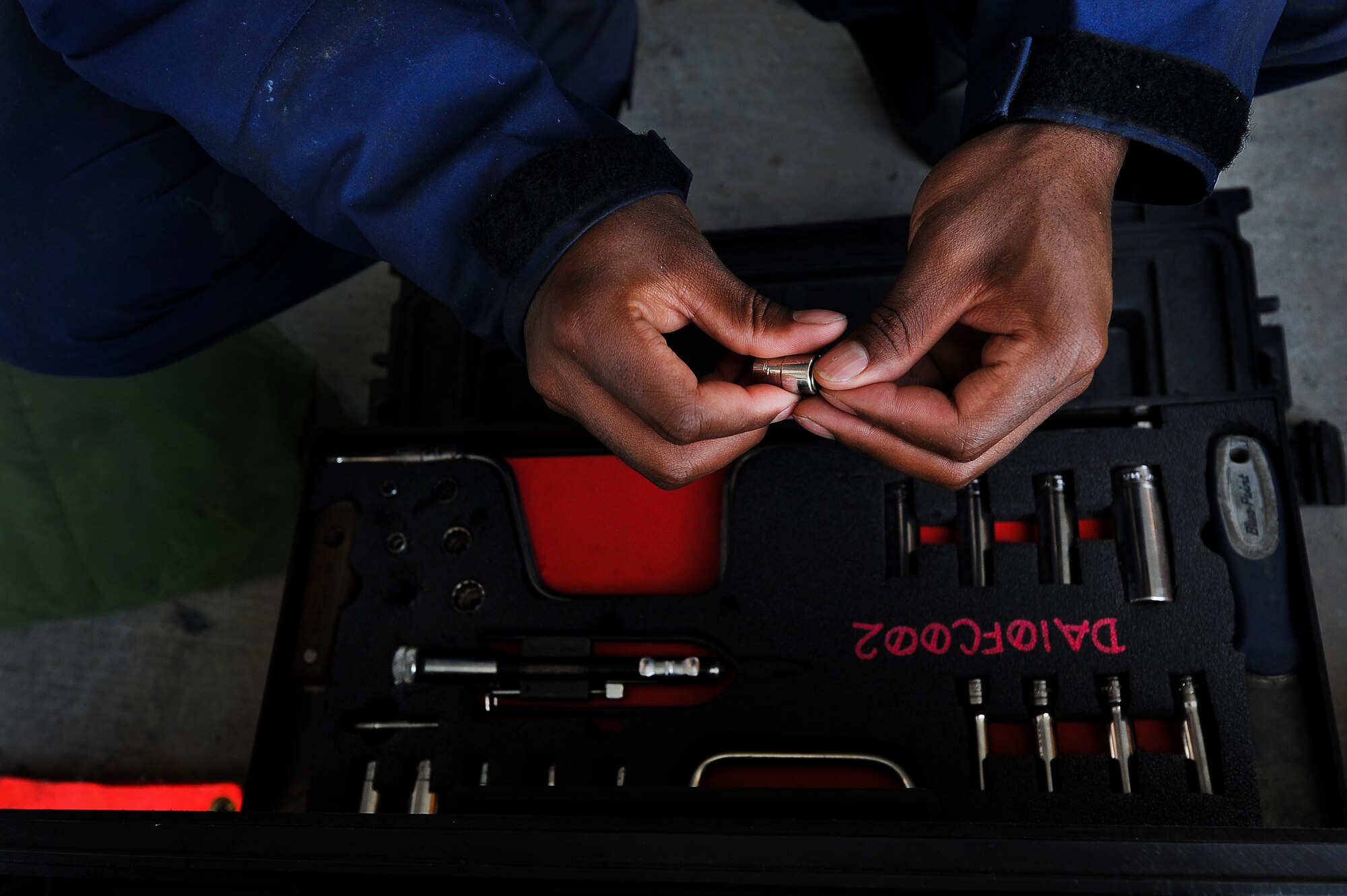 Senior Airman Tyree Bishop, a 380th Expeditionary Aircraft Maintenance Squadron fuel systems journeyman, selects tools needed for a bladder cell installation on a KC-10 Extender April 28, 2014, at an undisclosed location in Southwest Asia. The KC-10 Extender is an aerial refueling aircraft which extends the reach of other aircraft.  (U.S. Air Force photo byTech. Sgt. Russ Scalf/Released)