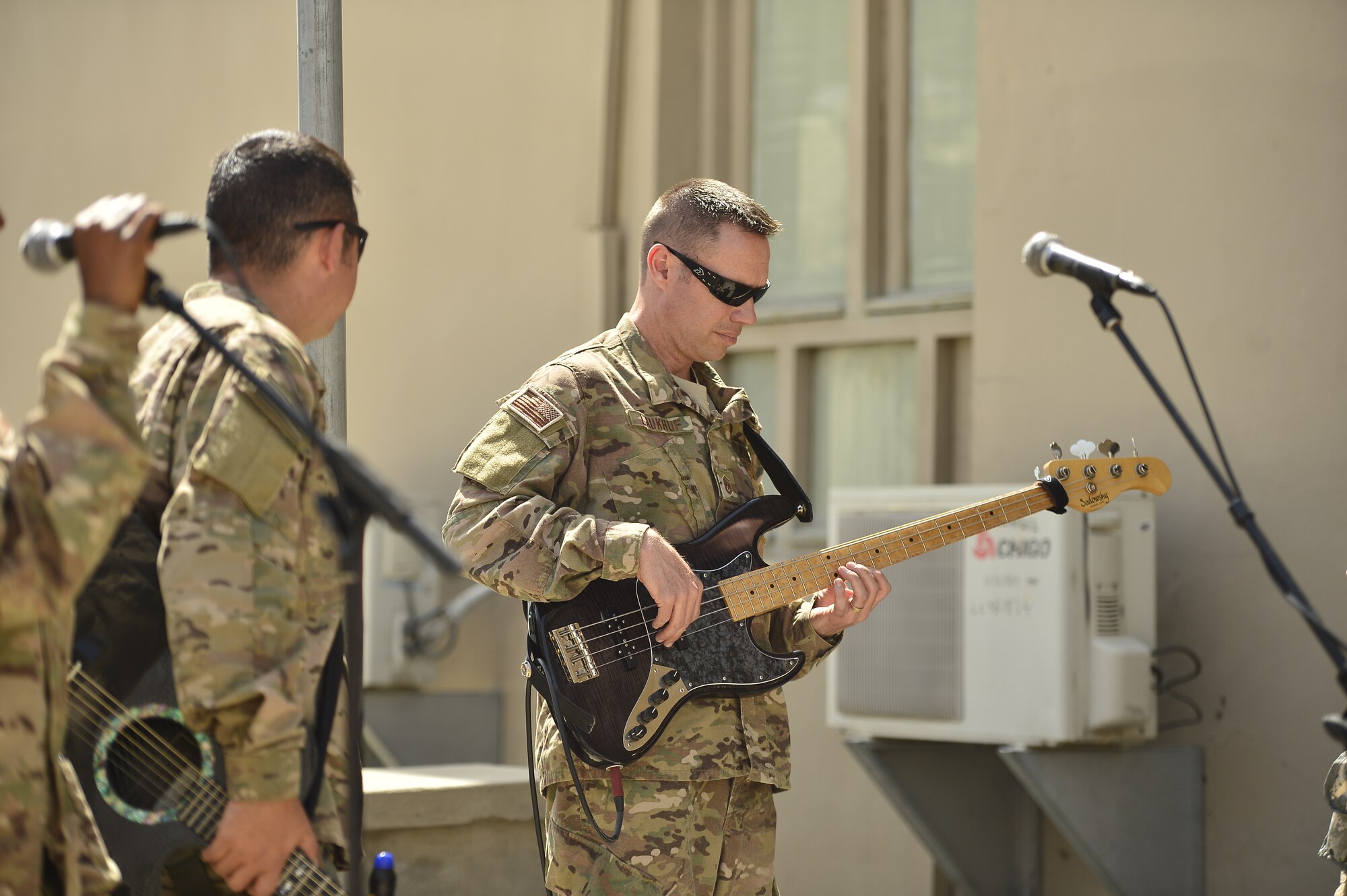 Master Sgt. Jeremy Laukhuf, Air Force Central Command Band NCO in charge, leads while performing for the Joint Combat Casualty Research Team at Bagram Air Base, April 11, 2014.  The AFCENT Band, Hypersonic, traveled 17 days through Afghanistan performing for service members and coalition forces helping to boost morale and build partnerships with local populations. (U.S. Air Force photo/Staff Sgt. Vernon Young))