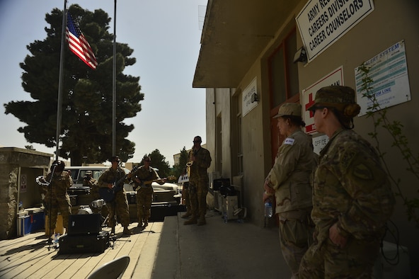 Members of the Joint Combat Casualty Research Team, Joint Trauma Theater Systems and the American Red Cross enjoy a live performance from the Air Force Central Command Band, Hypersonic, at Bagram Air Base April 11, 2014.  The day’s performances were dedicated to those people who save live in the region. (U.S. Air Force photo/Staff Sgt. Vernon Young)