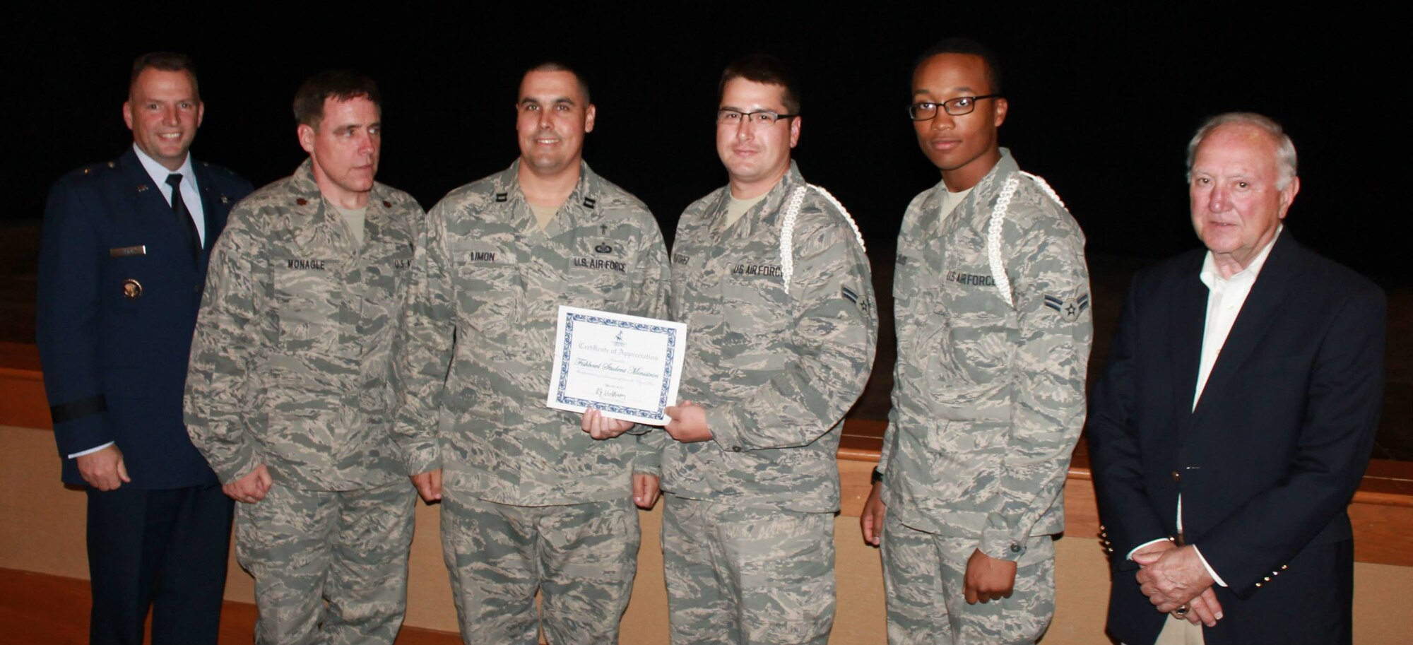Brig. Gen. Patrick Higby, 81st Training Wing commander, and Biloxi Mayor A.J. Holloway flank representatives of the Fishbowl Student Ministry Center's white rope program -- from left, Chaplain (Maj.) Robert Monagle, Chaplain (Capt.) Mathew Limon and Airman 1st Class Jason Greatorex and Airman Basic James Rejouis, 338th Training Squadron.  The white ropes were named Biloxi's military volunteer group of the year.
